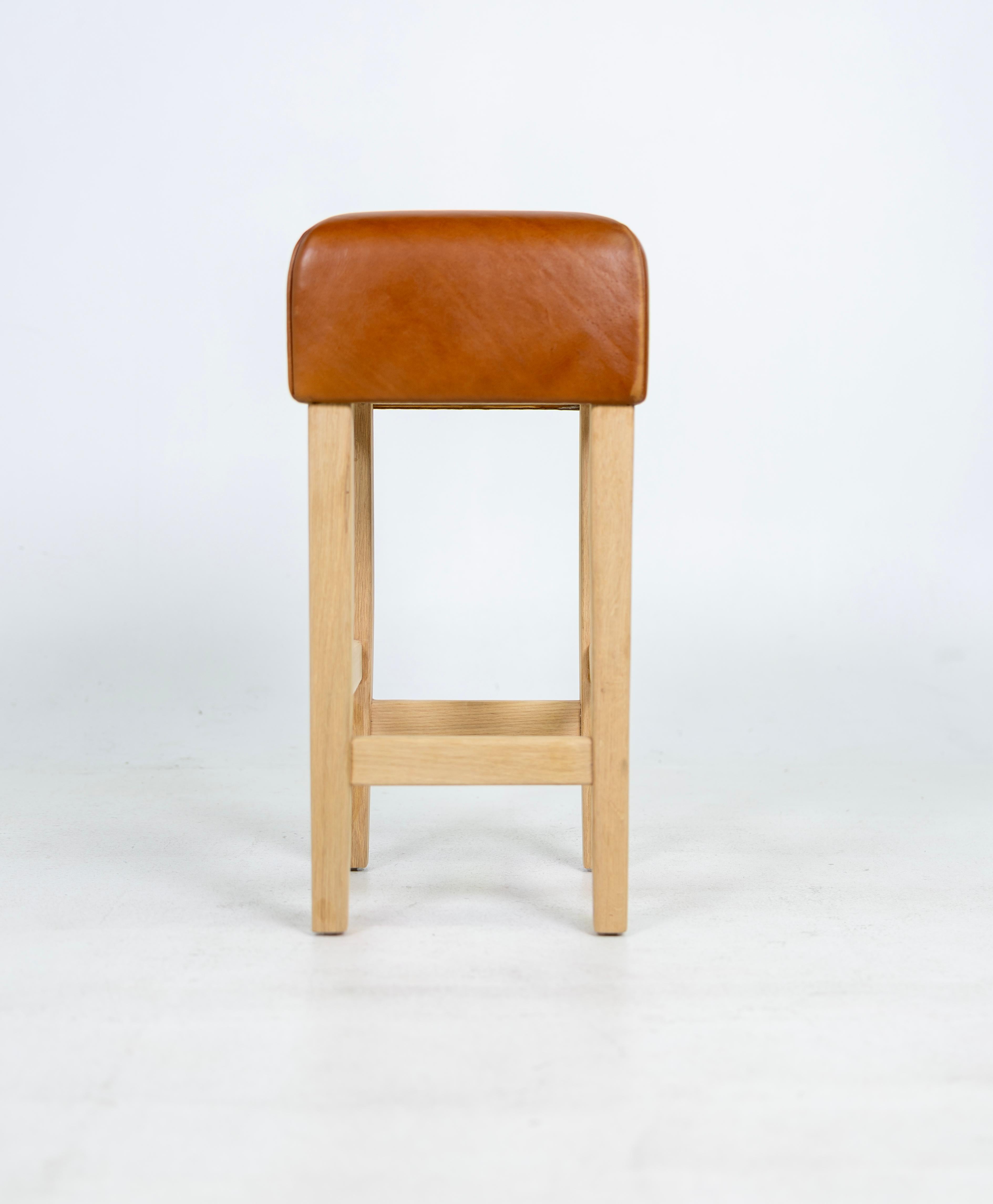 Beautiful Bar Stools in the Style of Jean-Michel Frank, white oak base with cognac leather seat. The Leather is very thick and white oak base is made to last forever. The Leather has a nice patina. The white oak base has no finish yet. The seller