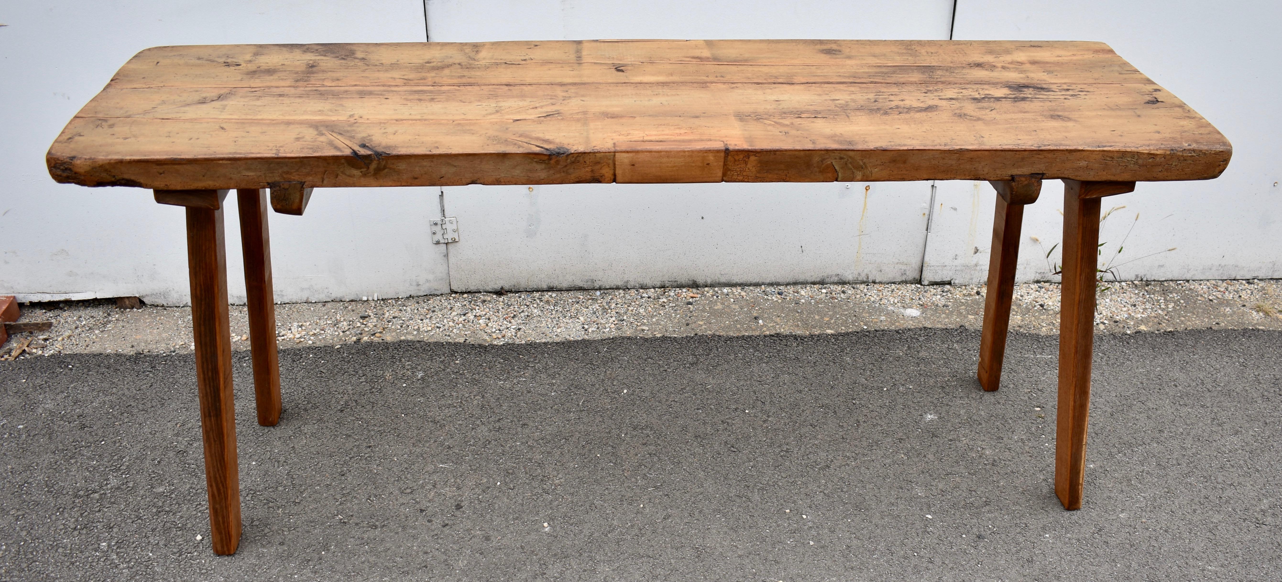 
The top of this large pig bench consists of two slabs of elm over 2” thick, spline- joined with two oak braces dovetailed into the underside as additional reinforcement.  At one end an iron staple is driven into the end grain.  At the other end an