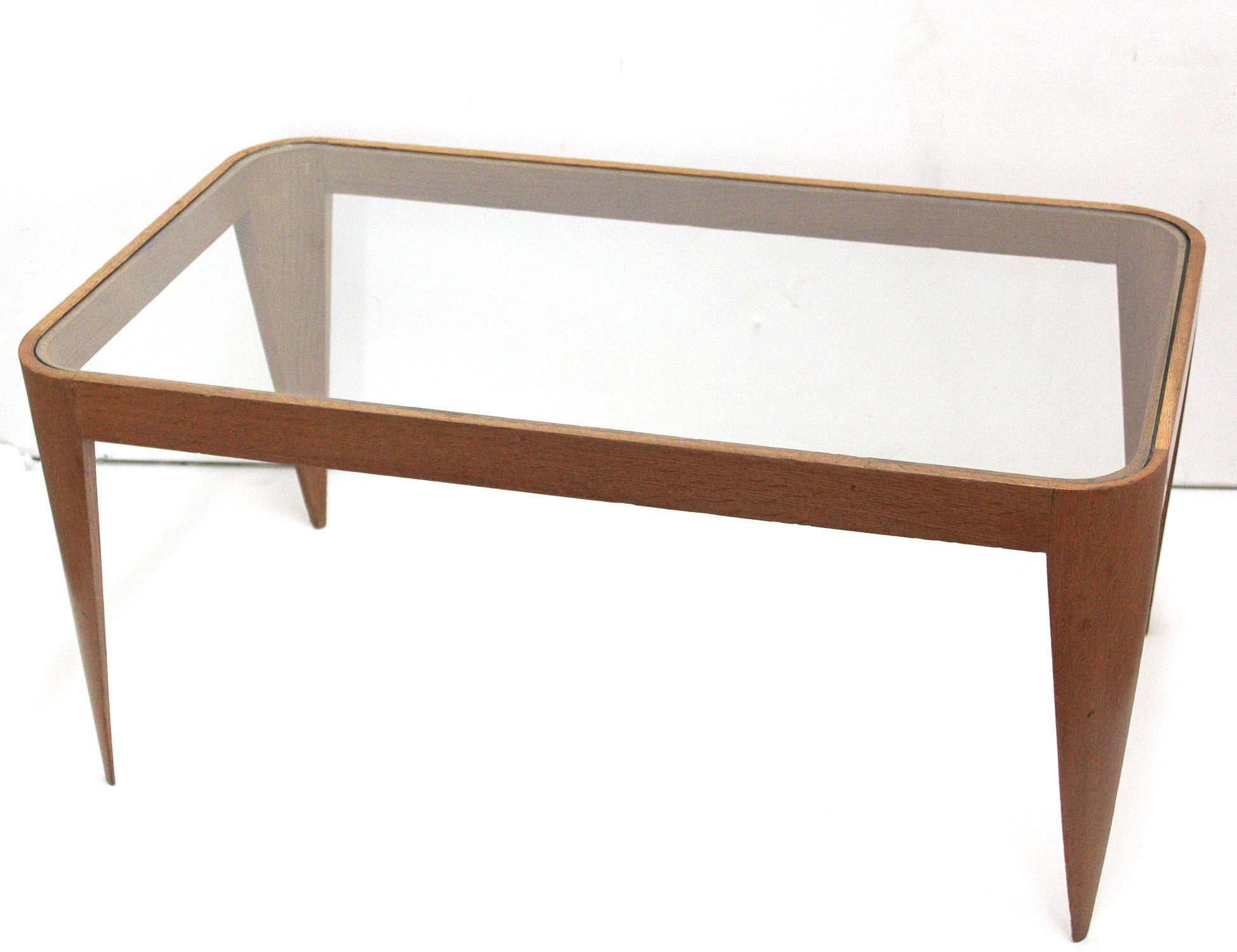 Italian stiletto-legged oak and glass coffee table, designed in 1940 by Gio Ponti. Its delicate, lightweight structure was an early study in the ideas used to great effect in his iconic 1957 Superleggera chair for Cassina.