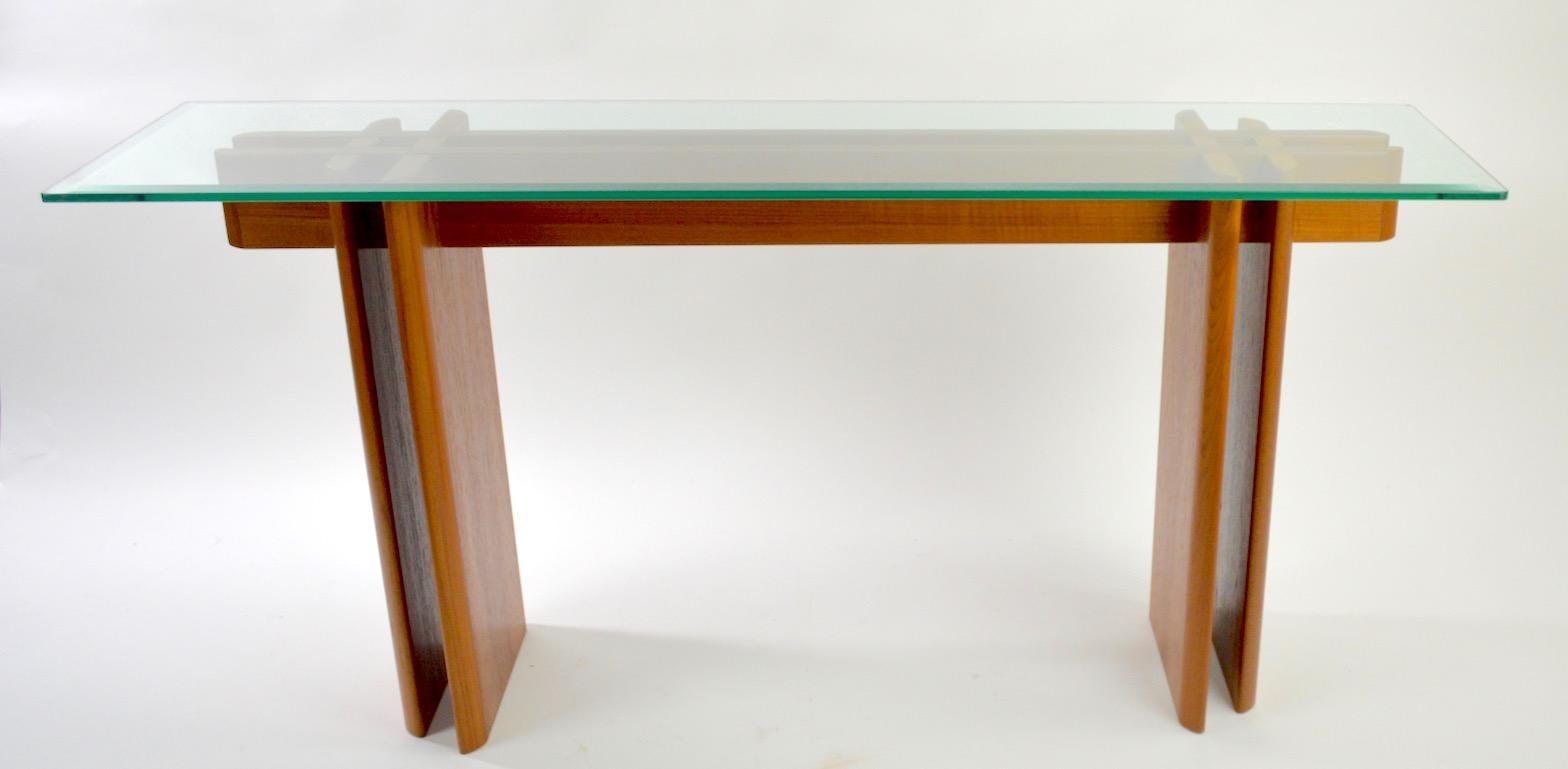 Nice modernist console table, solid oak base with bevelled plate glass top, attributed to Baughman. Very clean original condition, ready to use. Dimensions of base alone w/o top 52.75 W x 12.5 depth x 27.5 height (inches) plate glass .50 inch top.