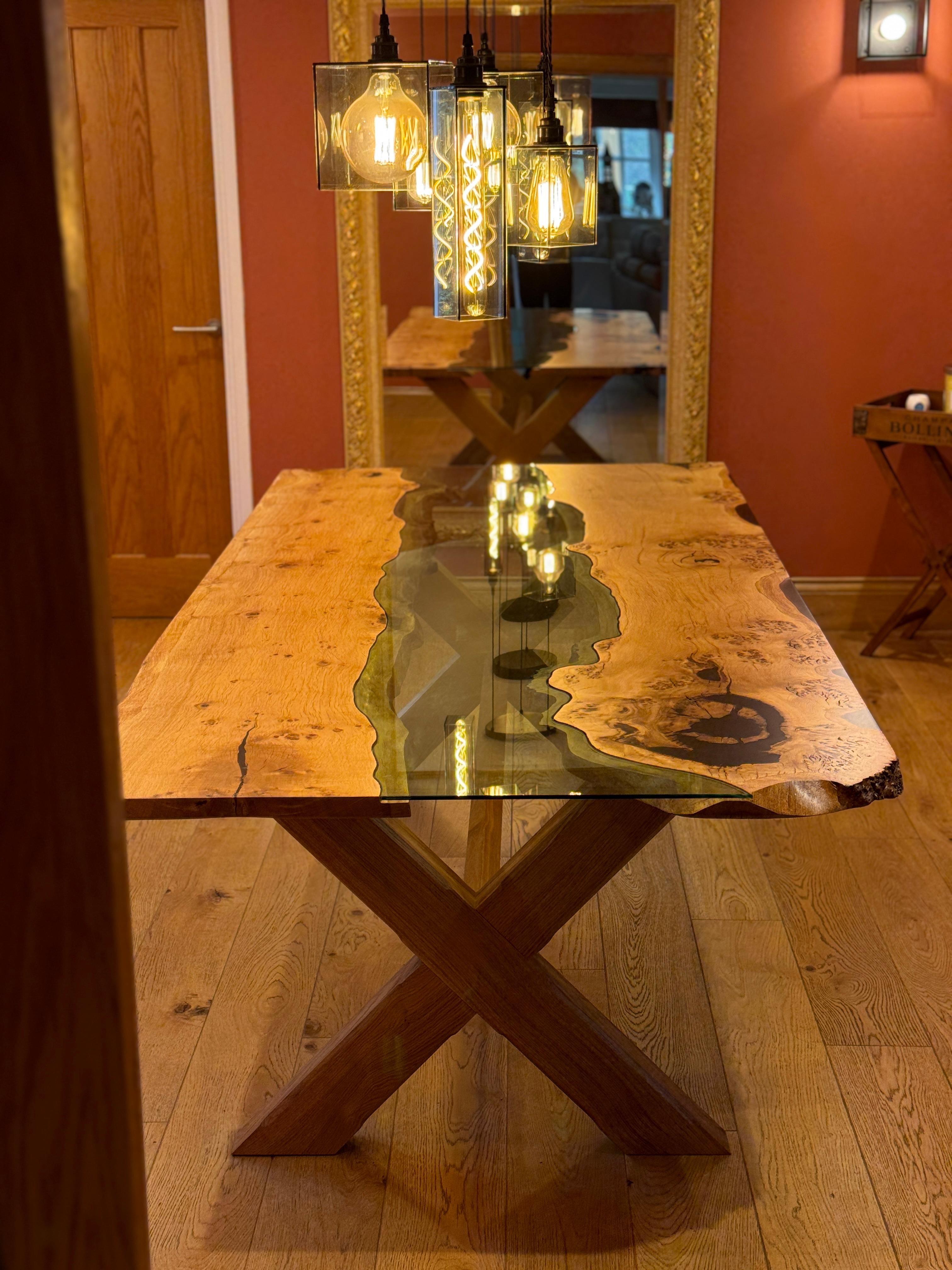 Oak dining table made from a rare sub species of oak; English Pippy Oak.
The oak is split down the middle and flipped before leaving a centre void.
The void is templated down to every single curve and movement of the natural waney edge of the