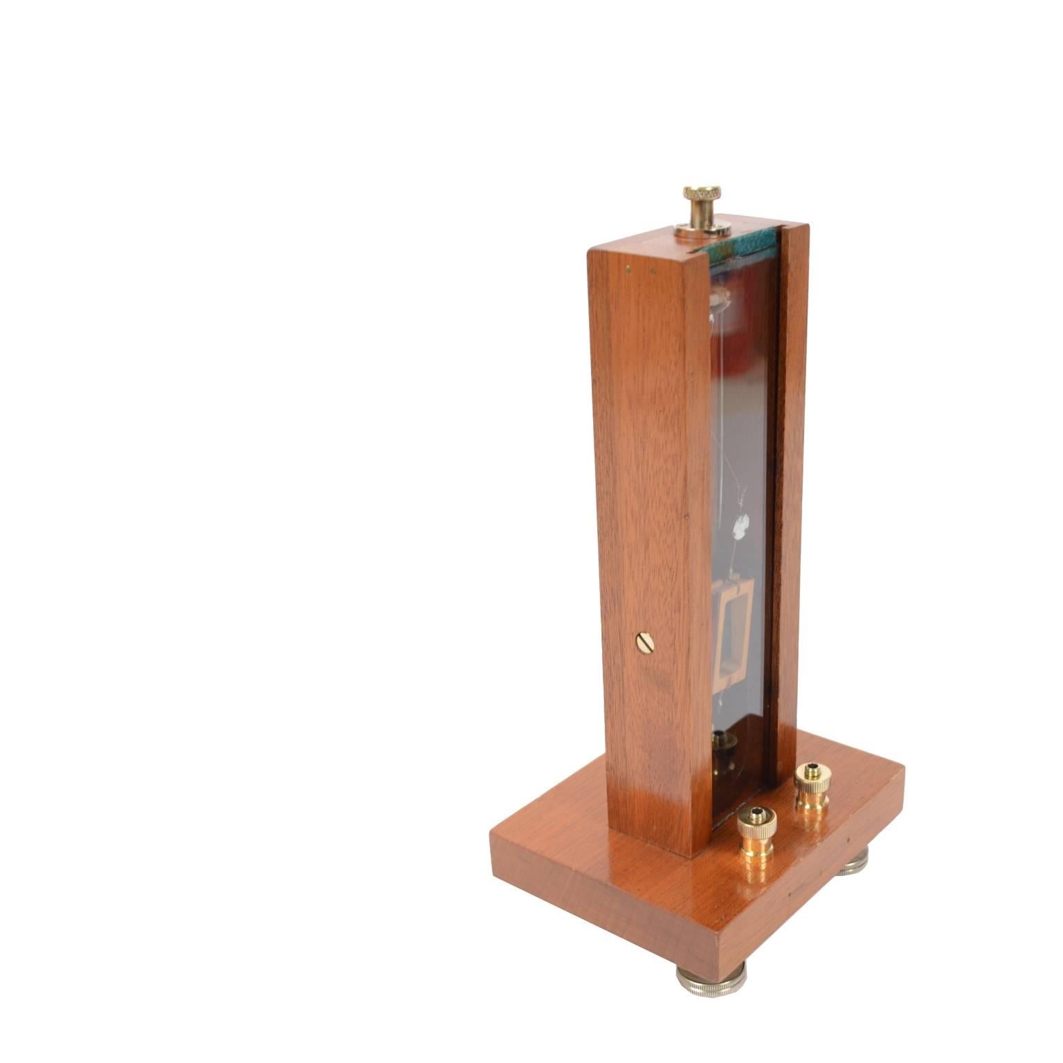 Vertical mirror galvanometer made in 1850 circa, oak and glass, three adjustable screws at the base. Tool constituted by a magnet bar movable inside a coil and connected to a needle. In the absence of current the needle is positioned vertically