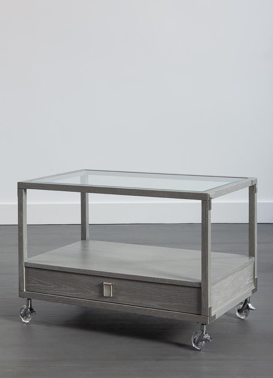 A very chic oak side table on lucite wheels with glass top and drawer is a perfect accompaniment to your sofa or armchairs. The added flexibility of wheels allows you to shift the table as appropriate to your room, including your bedroom where this