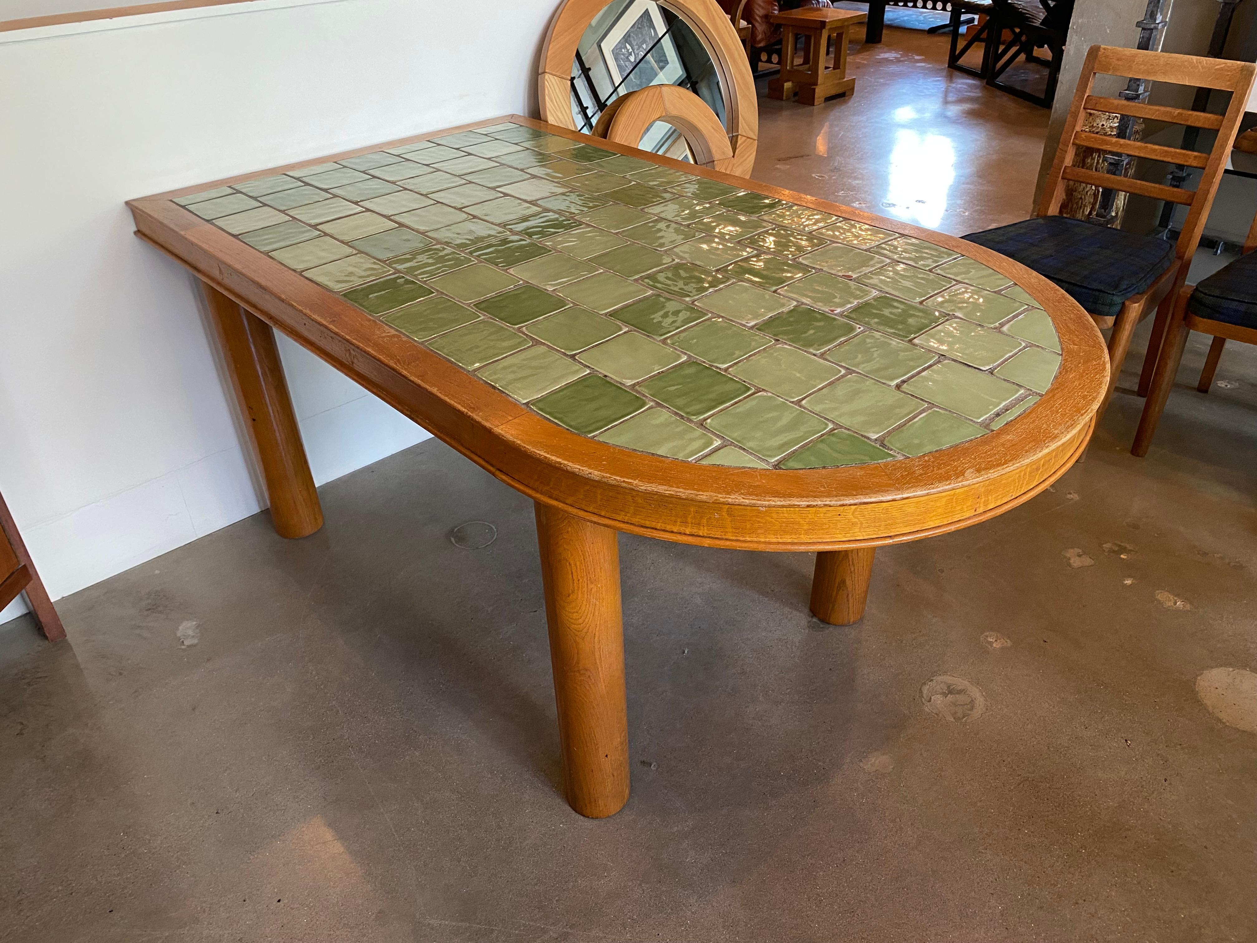 French oak dining table with inset green ceramic tile top. Straight on one end and rounded on the other, can abut a wall if desired. In the style of Guillerme et Chambron. France, 1940-50's.