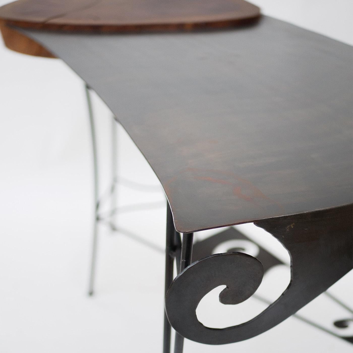 A splendid marriage between solid oak and wrought iron, this enchanting and sophisticated desk will make a refined statement in any private study or bedroom. The smooth curves and curled details enlivening the top and the stretcher connecting the