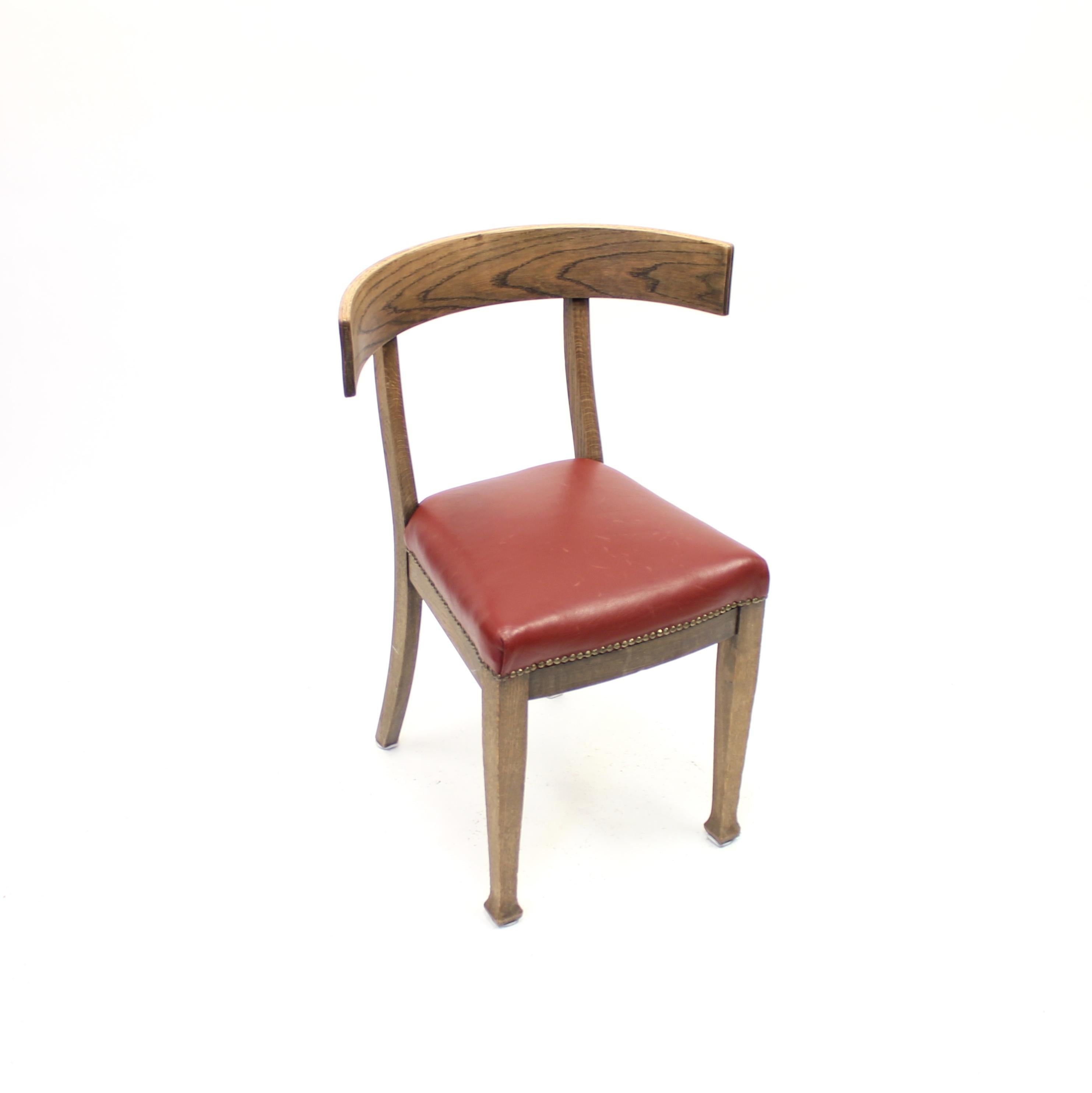 Oak Klismos chair with red leather seat made in the early part of the 20th century. The red leather is of a later date. most likely Scandinavian and made in Sweden. Some scratches and marks to the leather but otherwise in good vintage condition with