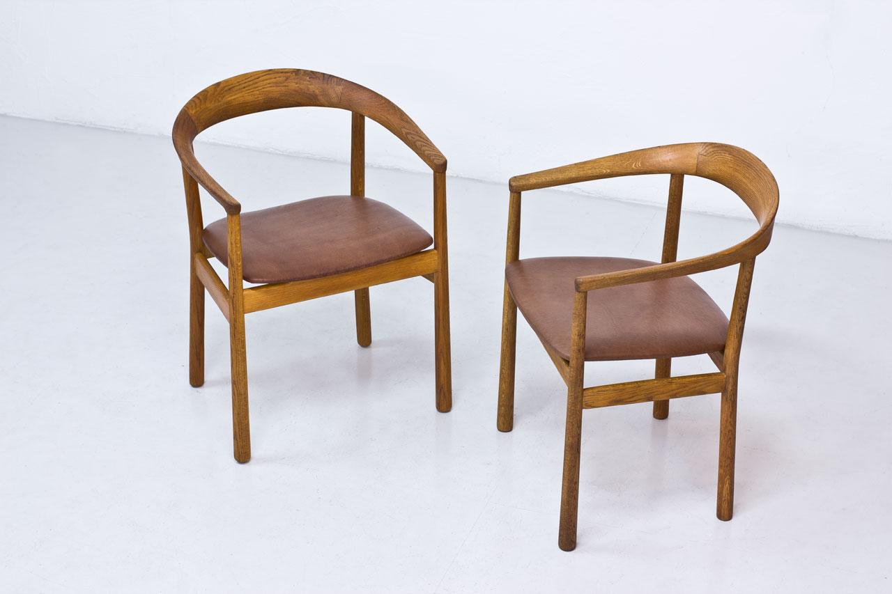 Pair of “Tokyo” chairs designed by architect Carl-Axel Acking. 
Originally designed for the Swedish Embassy in Tokyo, 1959. 
Manufactured by Nordiska Kompaniet (NK) in Sweden. 
Solid oak frame, newly reupholstered with patinated brown leather.