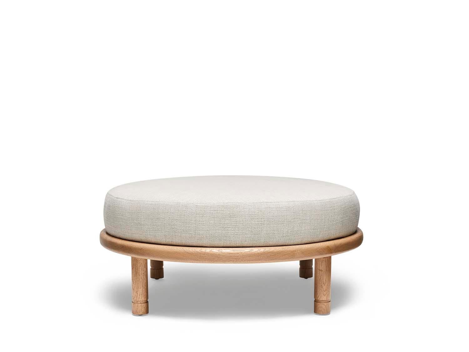 Oak and linen Moreno Ottoman by Lawson-Fenning. The Moreno Ottoman features a round solid wood base with four cylindrical legs and an upholstered top. Available in American walnut or white oak. 

The Lawson-Fenning Collection is designed and