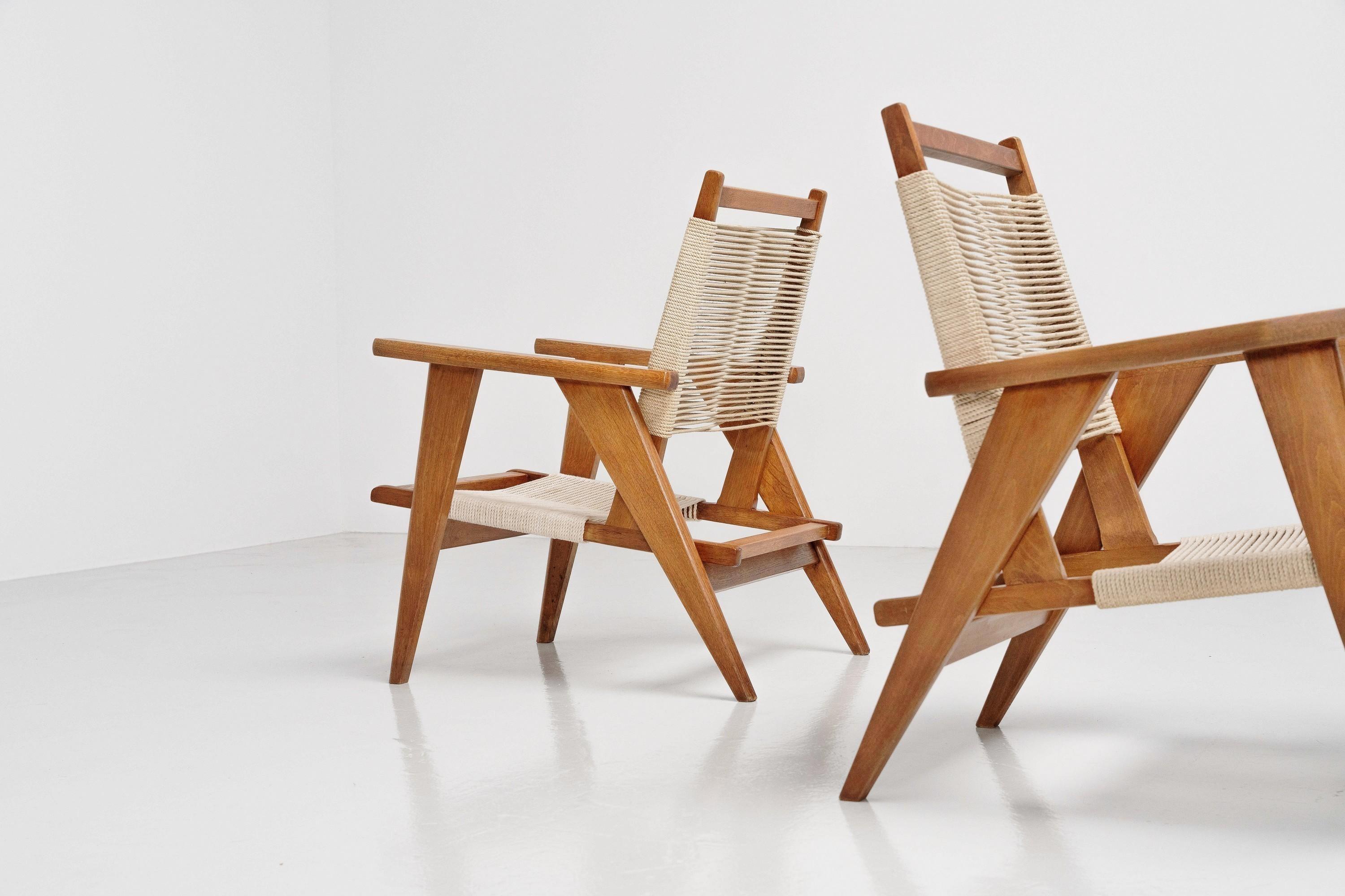 Very curious and nice pair of French lounge chairs in Oak wood with woven ropes for seating made in France in the 1950s. We could not determin their maker, but these chairs clearly resemble the spirit of French Avant-Gardism and Modernism, and