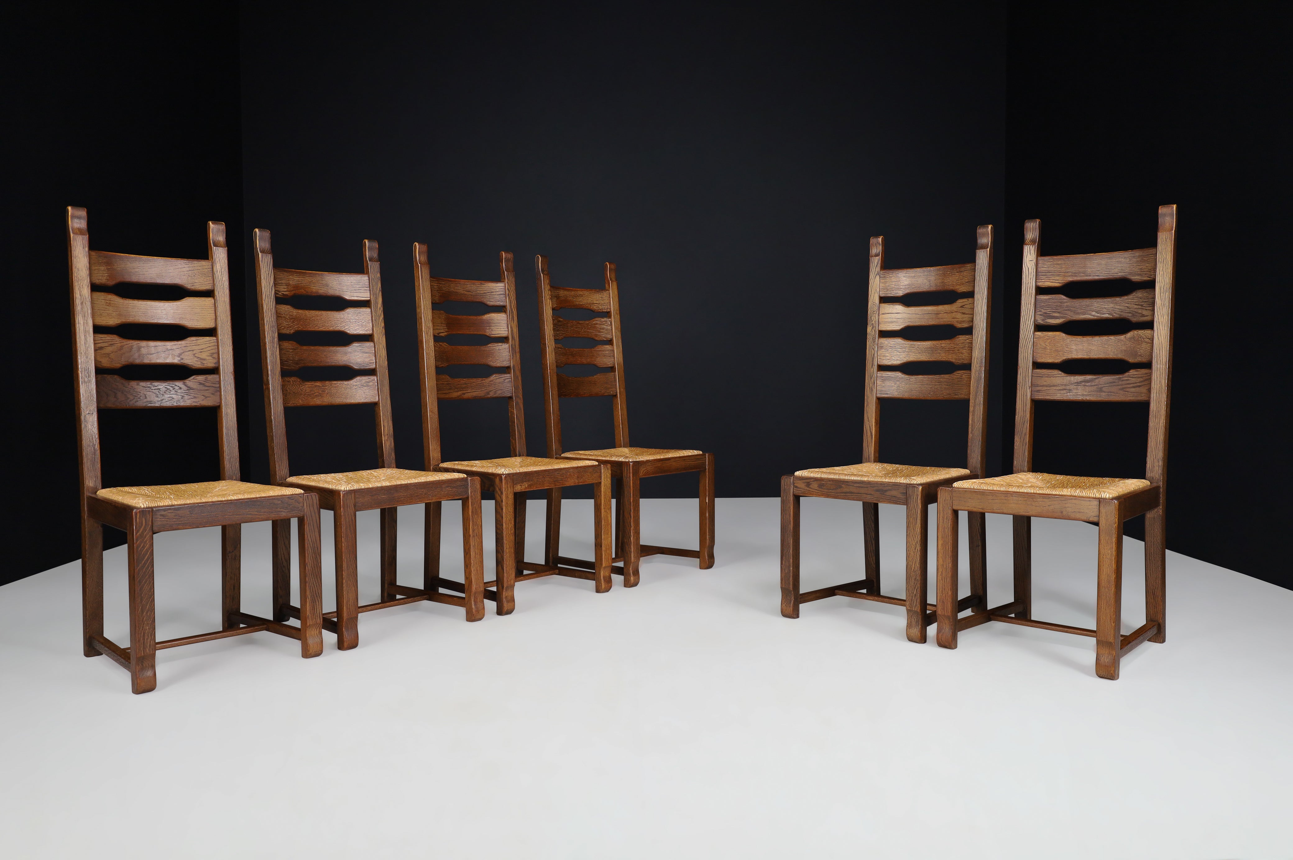 Oak and rush high back dining chairs, France, 1960s 

Set of six high back oak and rush dining chairs, France, 1960s. These chairs are made entirely of oakwood and rush. They are in excellent original condition. The color of the wood is very warm