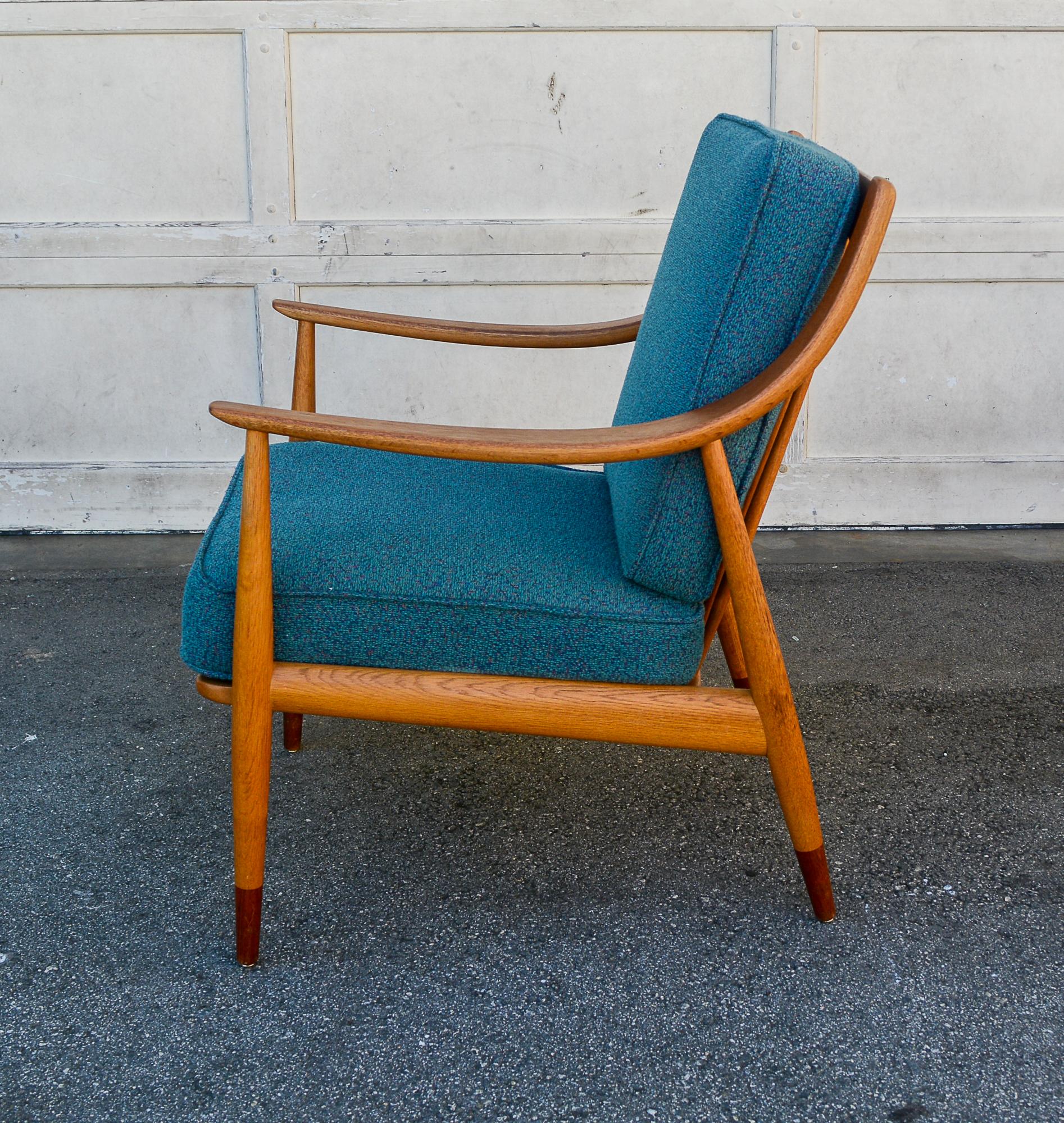 Lounge chair designed by Peter Hvidt and Orla Molgaard-Nielsen. This chair was made by France and Daverkosen of Denmark and retailed by John Stuart in the United States. This is the more desirable version of this chair with an oak frame and teak