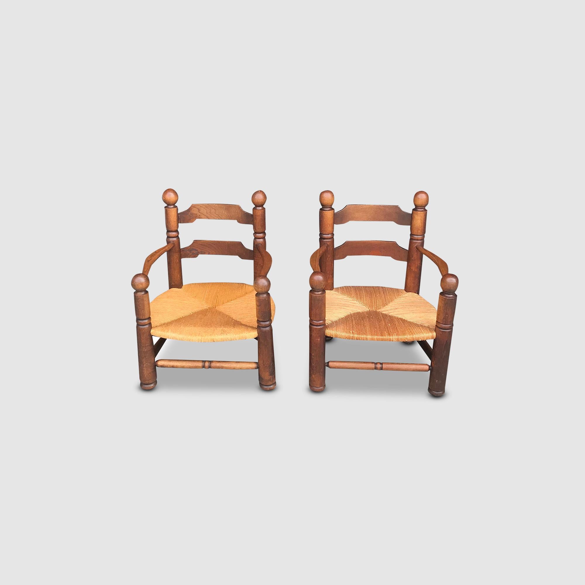 Rustic Oak and wicker Fireside armchair by Charles Dudouyt France 1950s, set of 2 For Sale