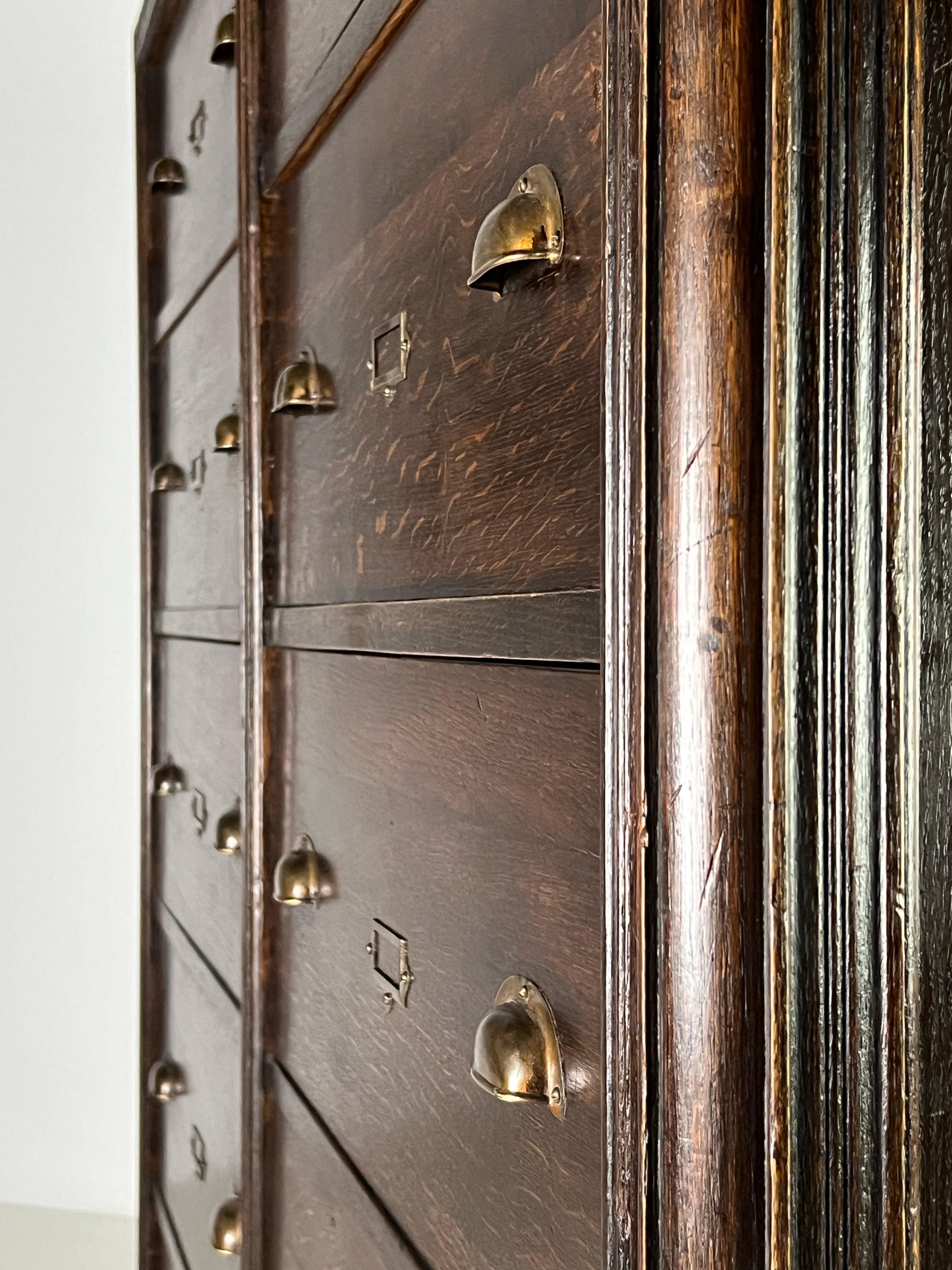 Very nice apothecary cabinet / chest of drawers. Made of solid oak. Dark in color. Probably from Belgium, ca. 1900.

Cabinet is very solid and heavy. Drawers run properly.

Dimensions: 172w x 170h x 68d