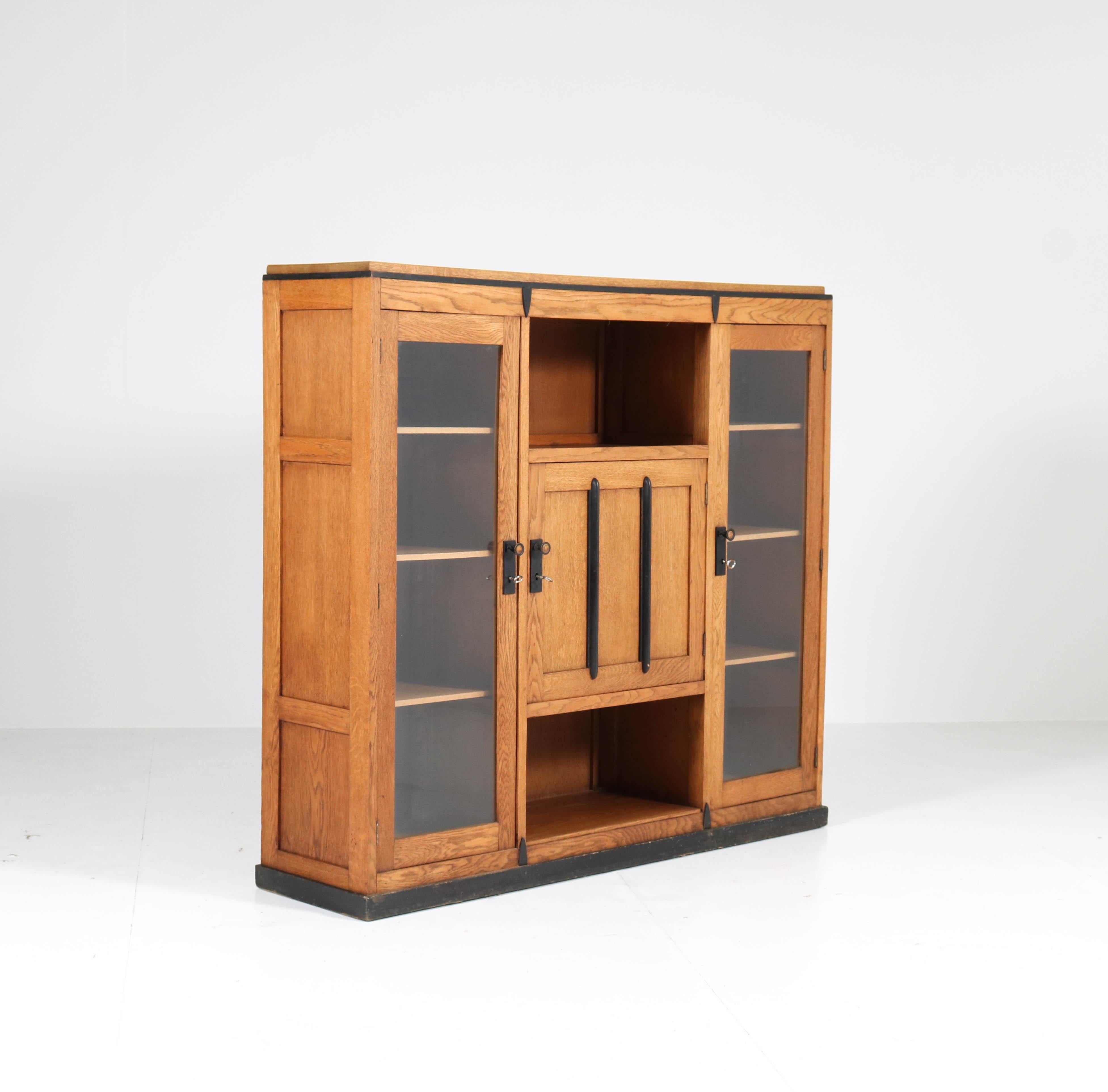 Wonderful and rare Art Deco Amsterdam School bookcase.
Striking Dutch design from the 1920s.
Solid oak with original ebonized lining.
Seven original oak shelves, adjustable in height.
In good original condition with minor wear consistent with