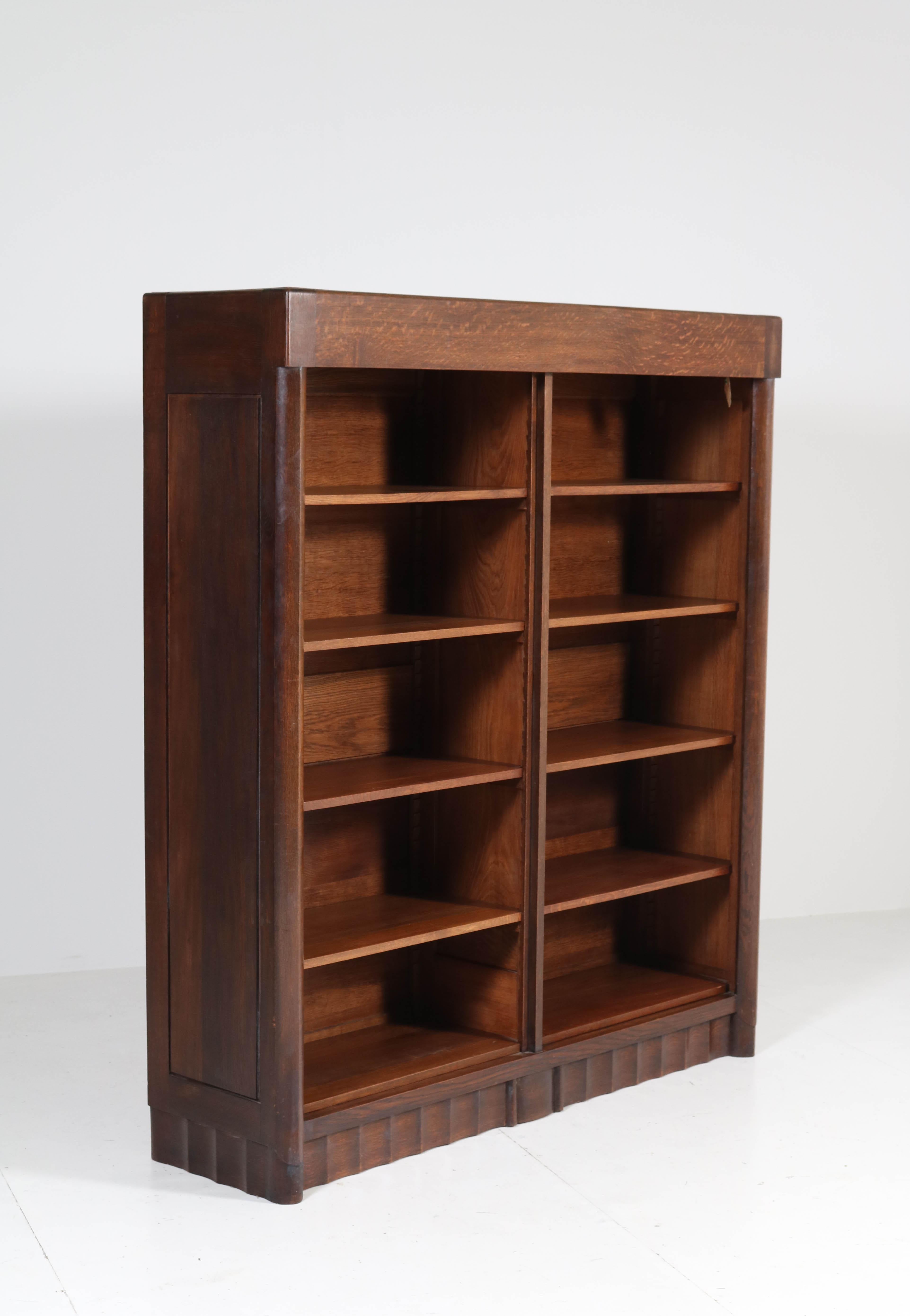 Wonderful and rare Art Deco Amsterdam School bookcase.
Design by Hildo Krop for Gebr. Monsieur Steenwijk.
Striking Dutch design from the twenties.
Solid oak with eight original solid oak shelves adjustable in height.
In good original condition