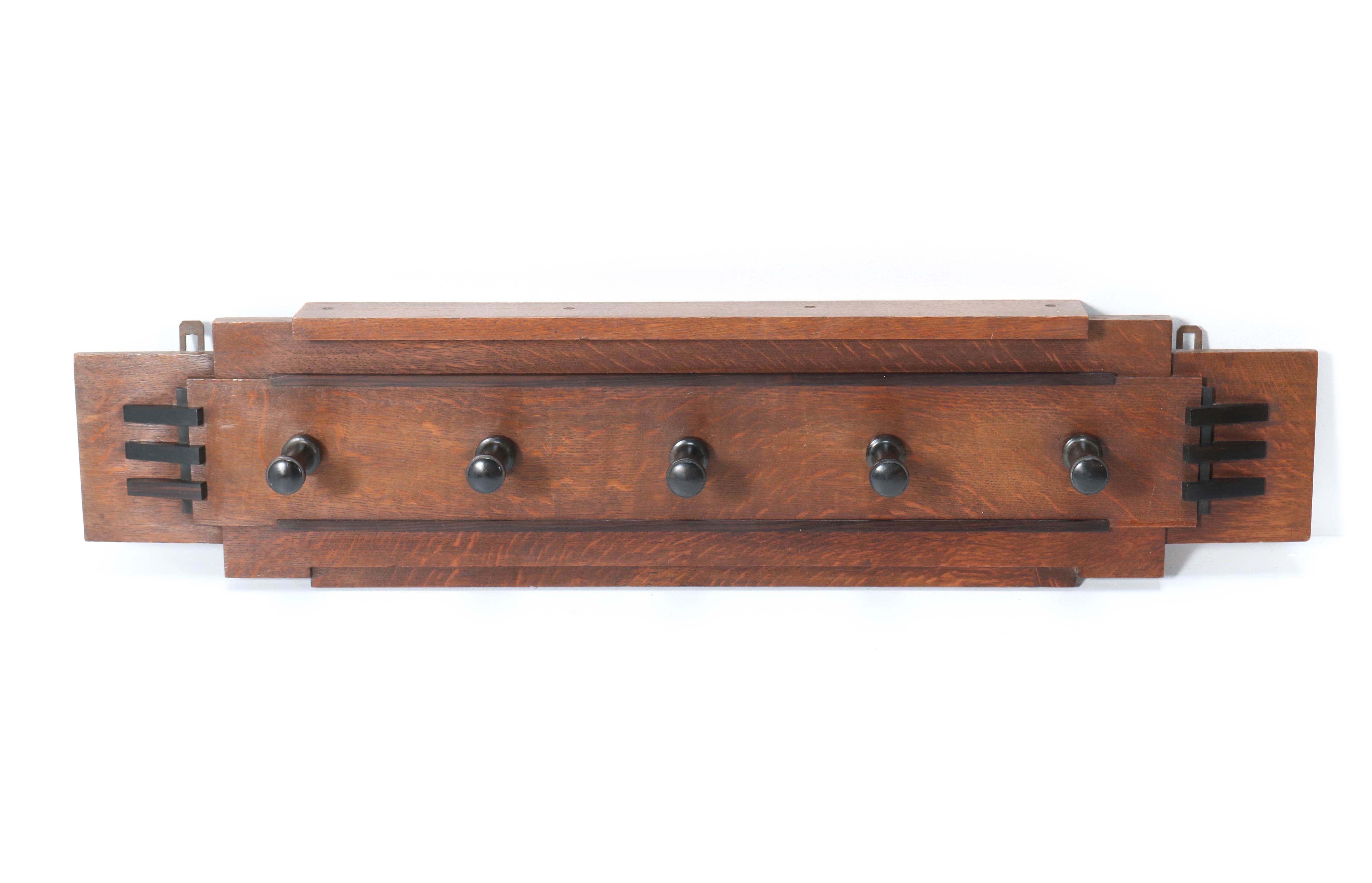 Wonderful and rare Art Deco Amsterdam School coat rack.
Striking Dutch design from the twenties.
Solid oak with solid Macassar ebony hooks and lining.
In very good condition with minor wear consistent with age and use,
preserving a beautiful