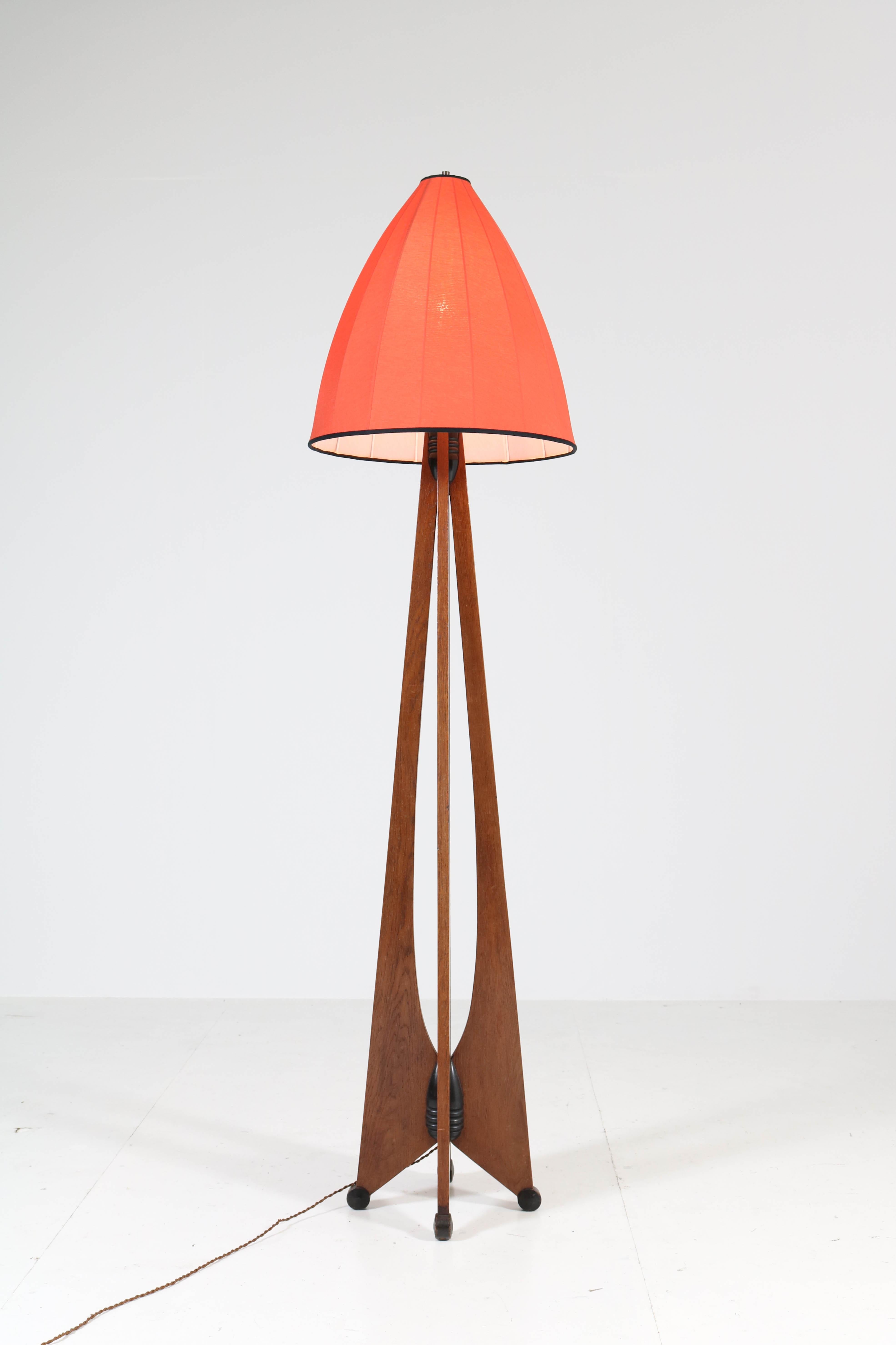 Stunning and rare Art Deco Amsterdam School floor lamp.
Design by J.J. Zijfers, Amsterdam.
Striking Dutch design from the 1920s.
Solid oak with original black lacquered details.
The shantung silk shade is custom made after an original model of