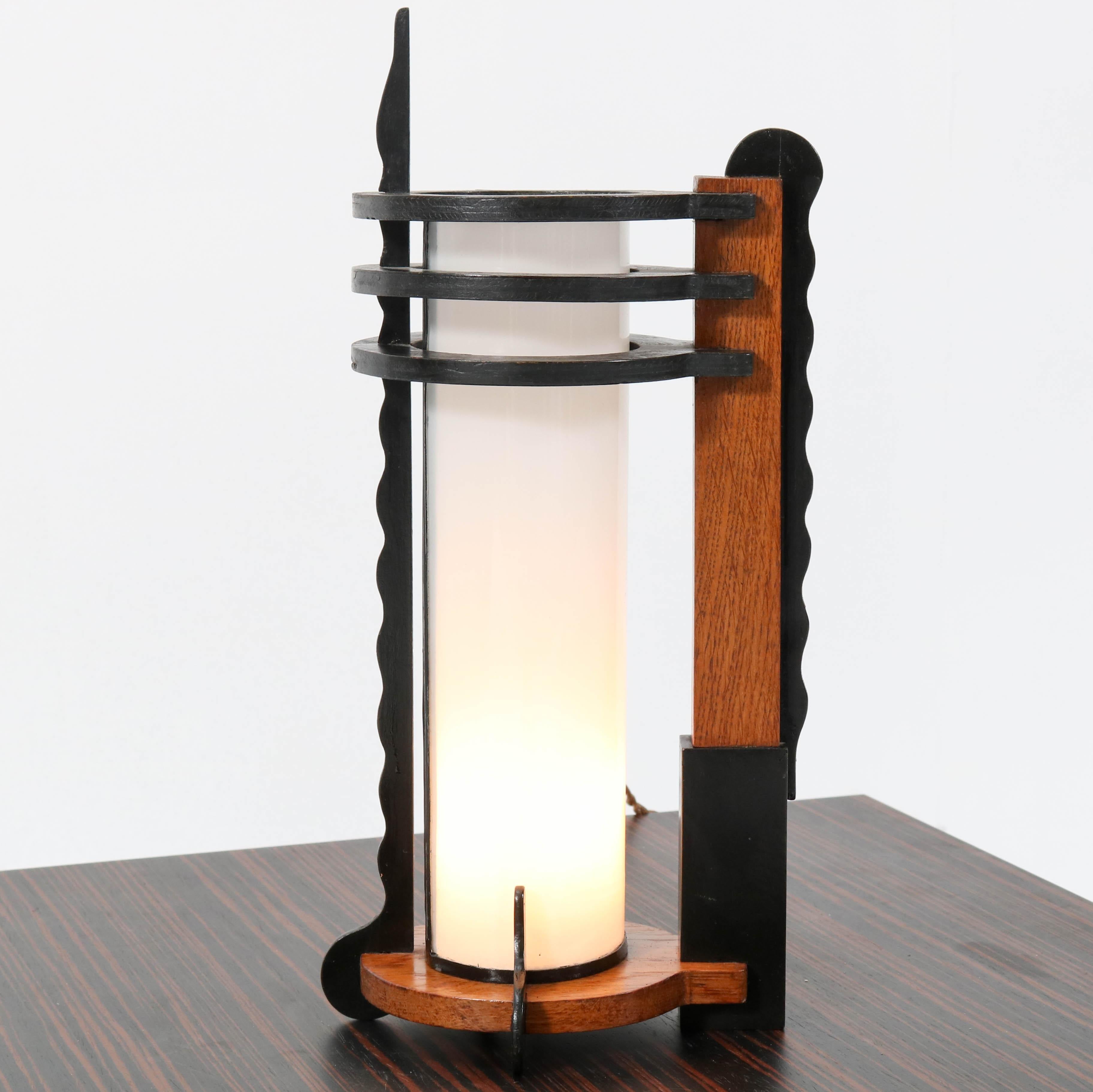 Magnificent and rare Art Deco Amsterdam School table lamp.
Striking Dutch design from the twenties.
Solid oak with original black lacquered mahogany.
Original milk glass shade.
Rewired with original socket for E.
In very good condition with a