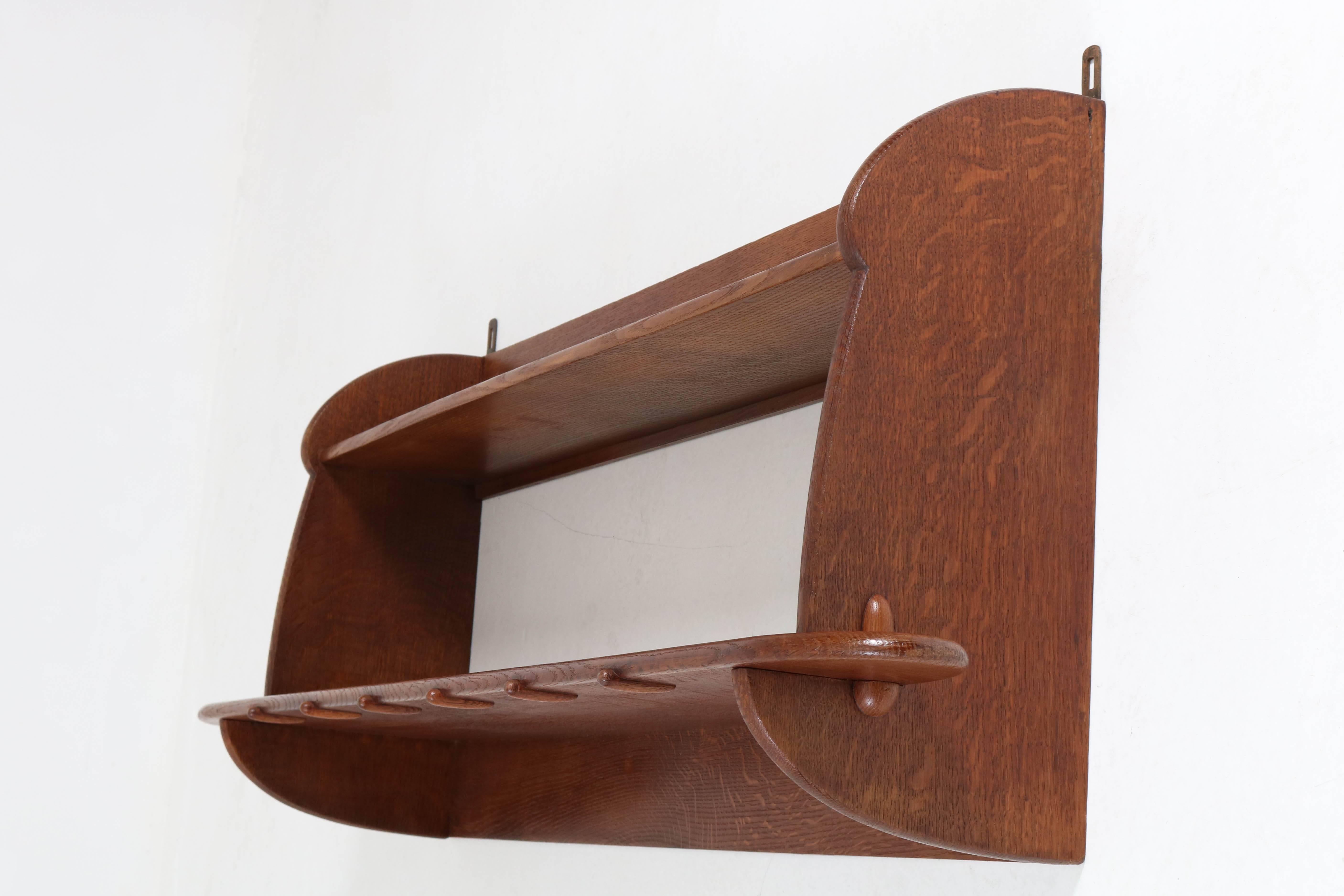 Rare Art Deco Amsterdam School wall book shelf by Paul Bromberg for Pander, 1920s.
Striking Dutch design from the twenties.
Solid oak and marked with metal tag and brand mark.
In good original condition with minor wear consistent with age and
