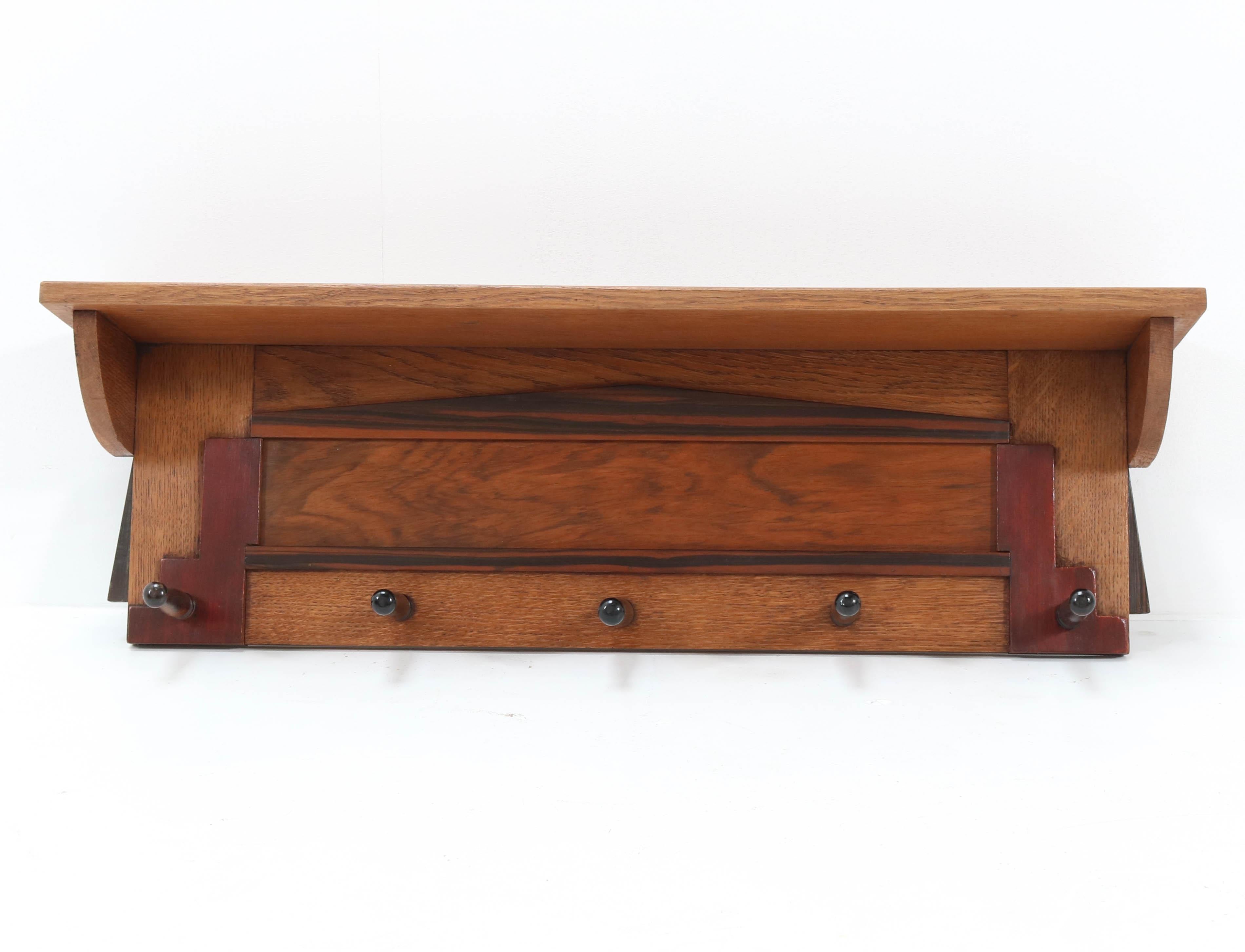 Stunning Art Deco Amsterdam School wall coat rack.
Striking Dutch design from the twenties.
Solid oak and solid macassar ebony and mahogany.
In very good condition with a beautiful patina.