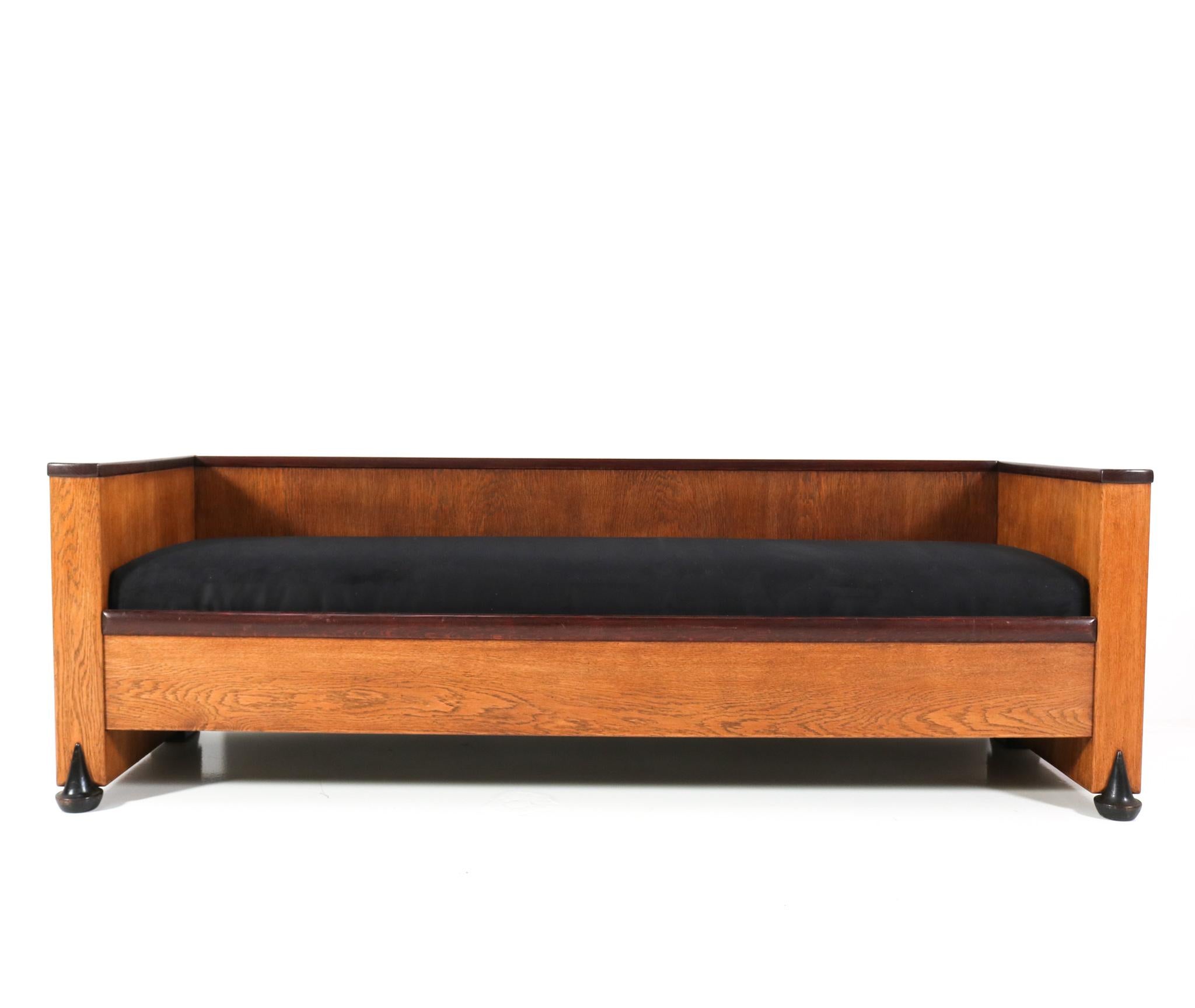 Stunning and very rare Art Deco Amsterdamse School bench or sofa.
Design attributed to Piet Kramer.
Striking Dutch design from the 1920s.
Solid oak with original oak veneer frame with original black lacquered details
at the feet.
The seat is