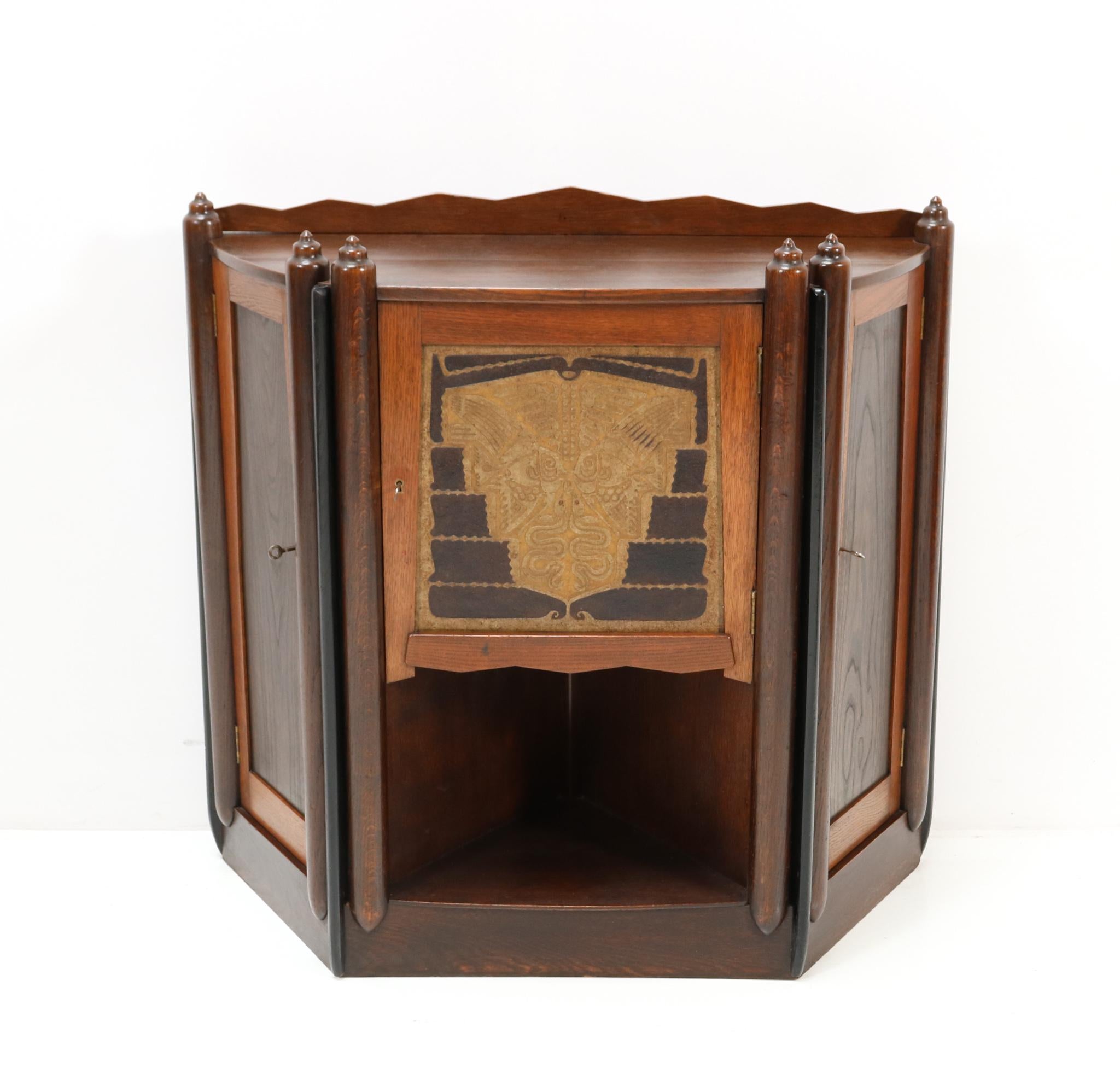Magnificent and ultra rare Art Deco Amsterdamse School cabinet. Design by Christiaan Bartels. Striking Dutch design from the 1920s. Solid oak frame with solid elm panels on the side doors. The middle door has a hand-carved and hand-painted panel