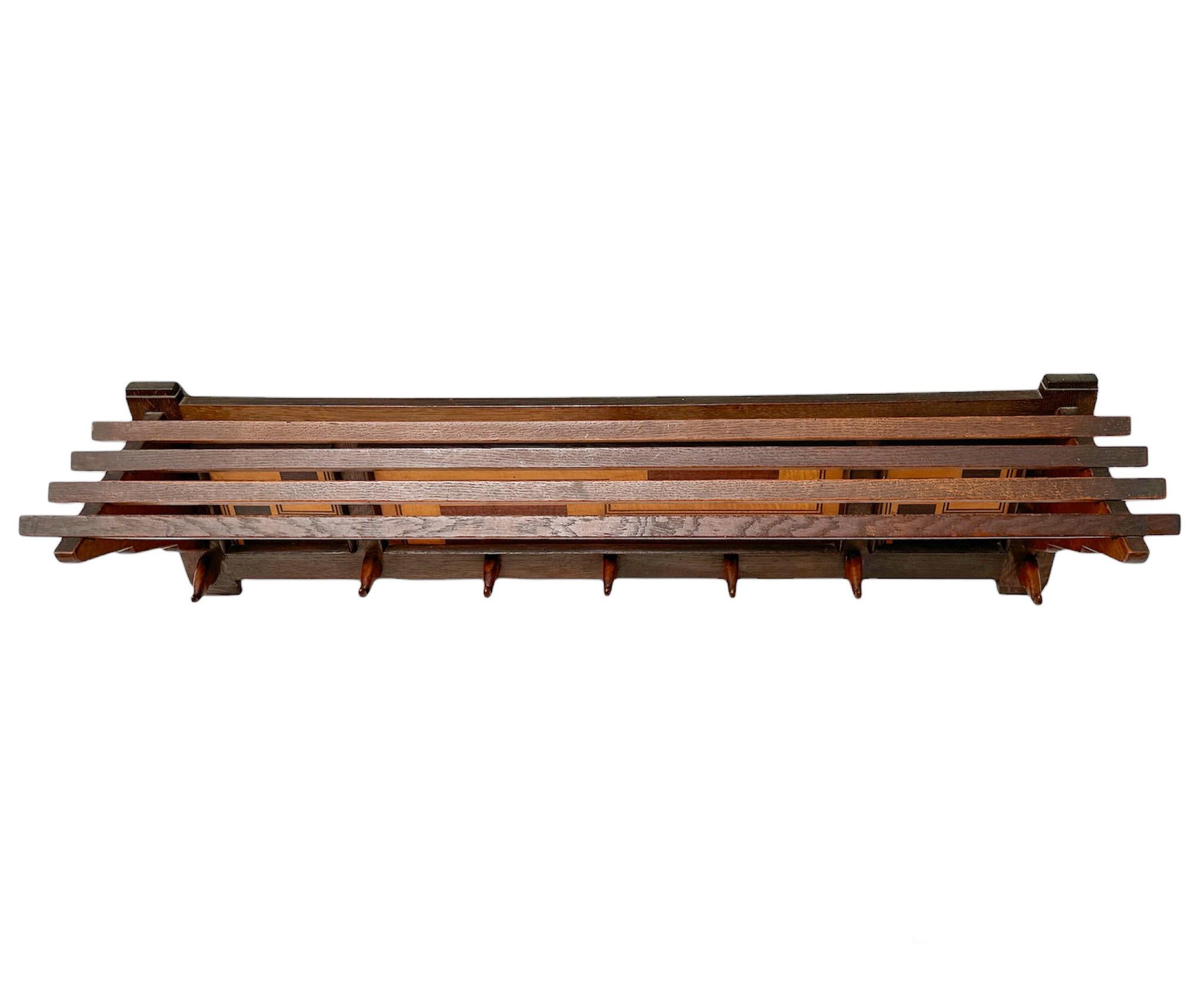 Magnificent and rare Art Deco Amsterdamse School coat rack.
Design by L.O.V. Oosterbeek.
Striking Dutch design from the 1920s.
Solid oak with original decorative satinwood details.
Seven original and stylish wooden hooks.
Marked with original