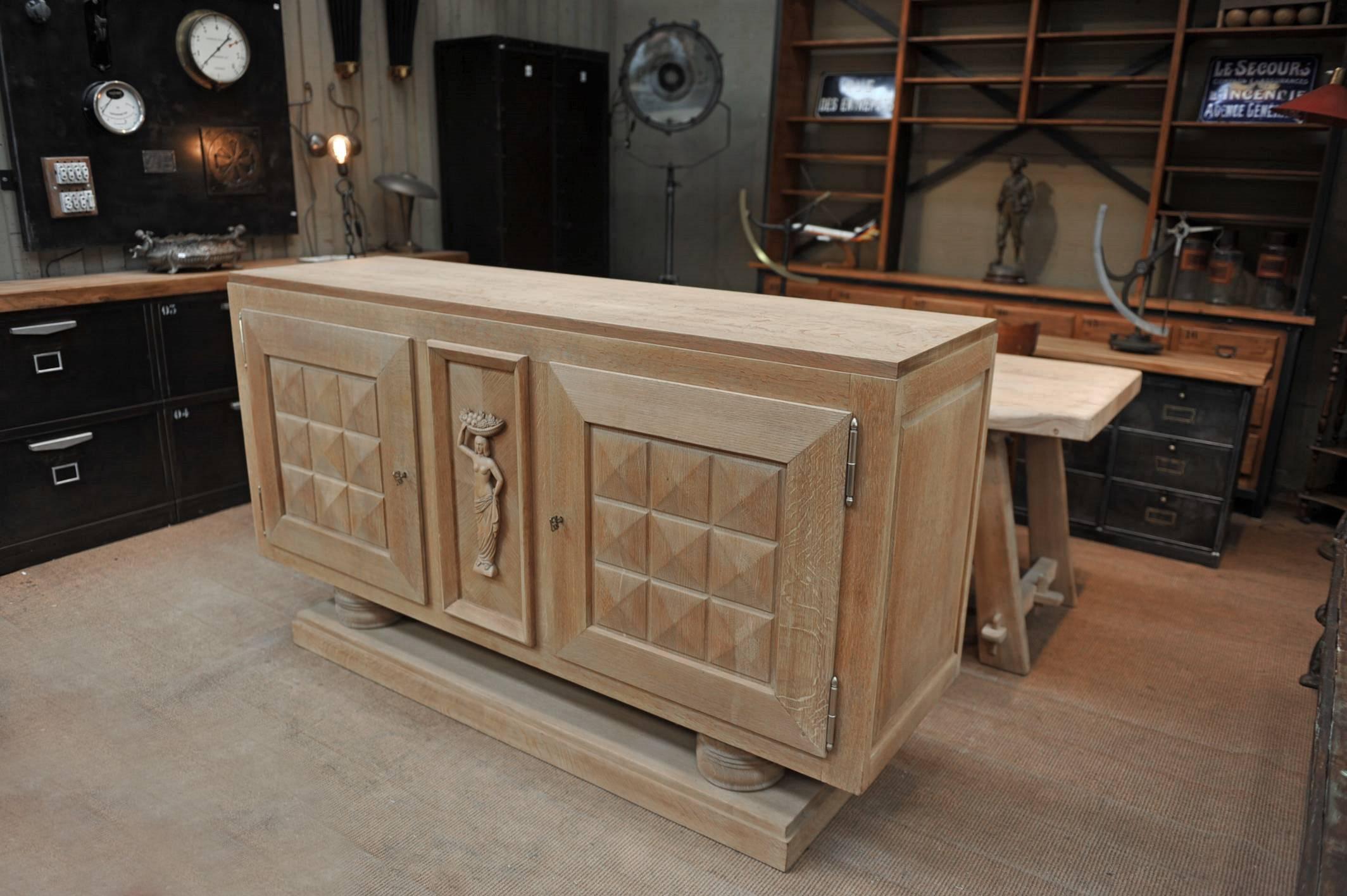 Art Deco credenza by Gaston Poisson with center carved fruit lady and two diamond graphical decor doors in natural sand oak.
Signed with two working brass Keys with initials GP for Gaston Poisson. The top comes of the base, circa 1930.





