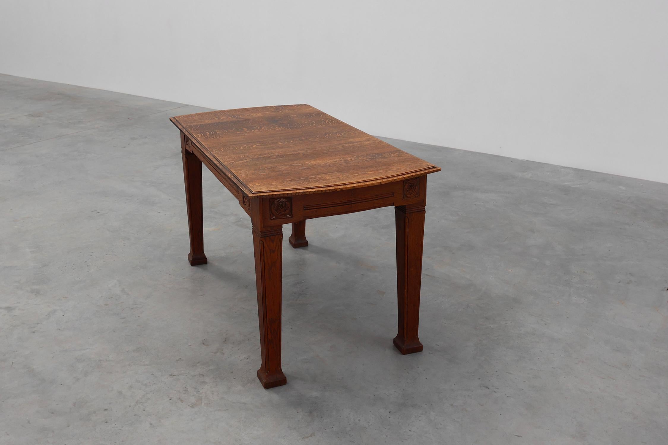 20th Century Oak Art Deco dining table with carved frieze, France 1920s For Sale
