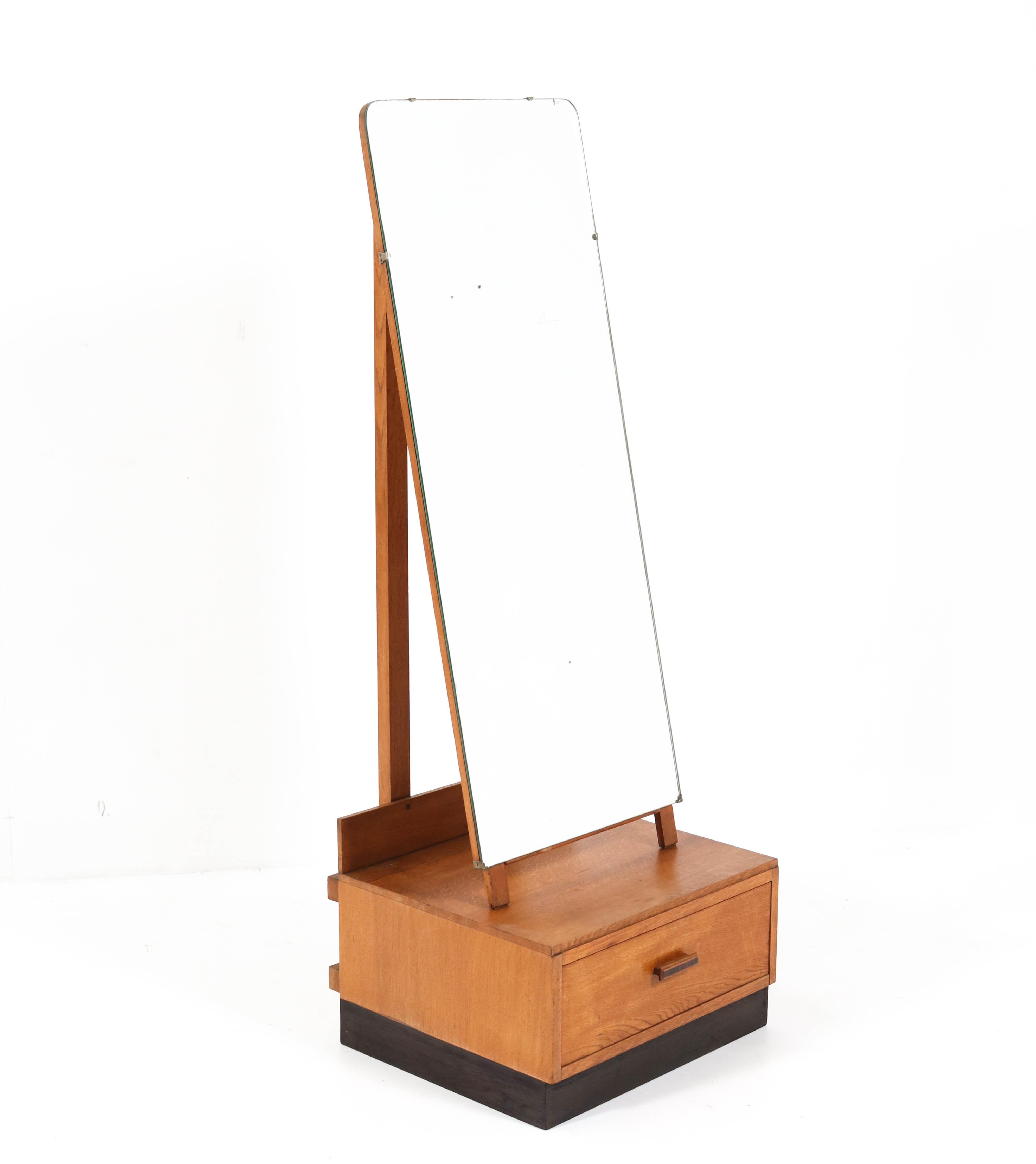 Stunning oak Art Deco full length standing mirror.
Design by
Striking English design from the 1930s.
Solid oak and original oak veneer base.
Original beveled mirror.
Marked with original manufacturers tag.
In very good original condition with