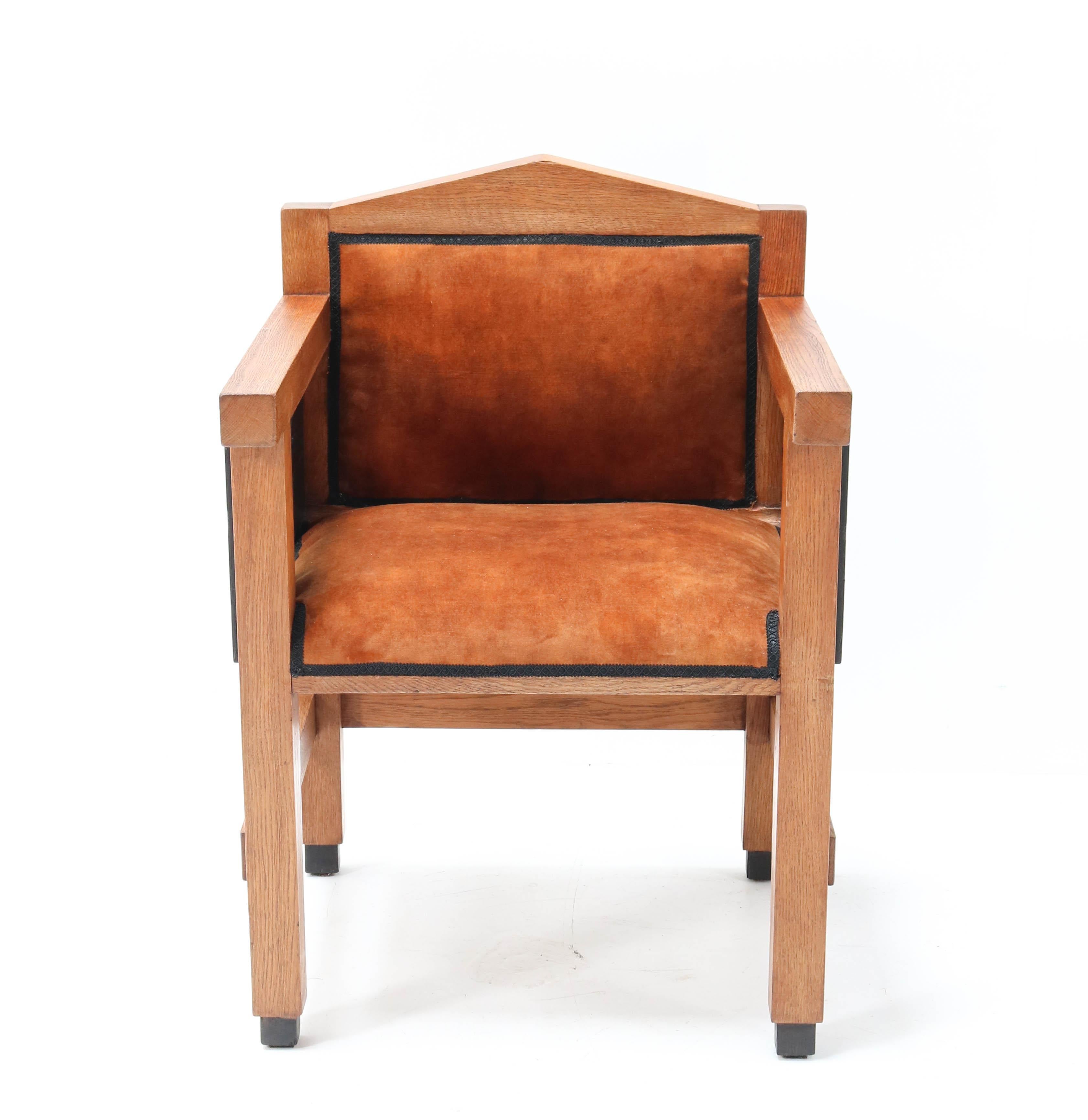 Magnificent and very rare Art Deco Haagse School armchair.
Design by Jacques Grubben.
Striking Dutch design from the 1930s.
Solid oak with original black lacquered details.
Re-upholstered with cognac colored velvet.
This wonderful piece of