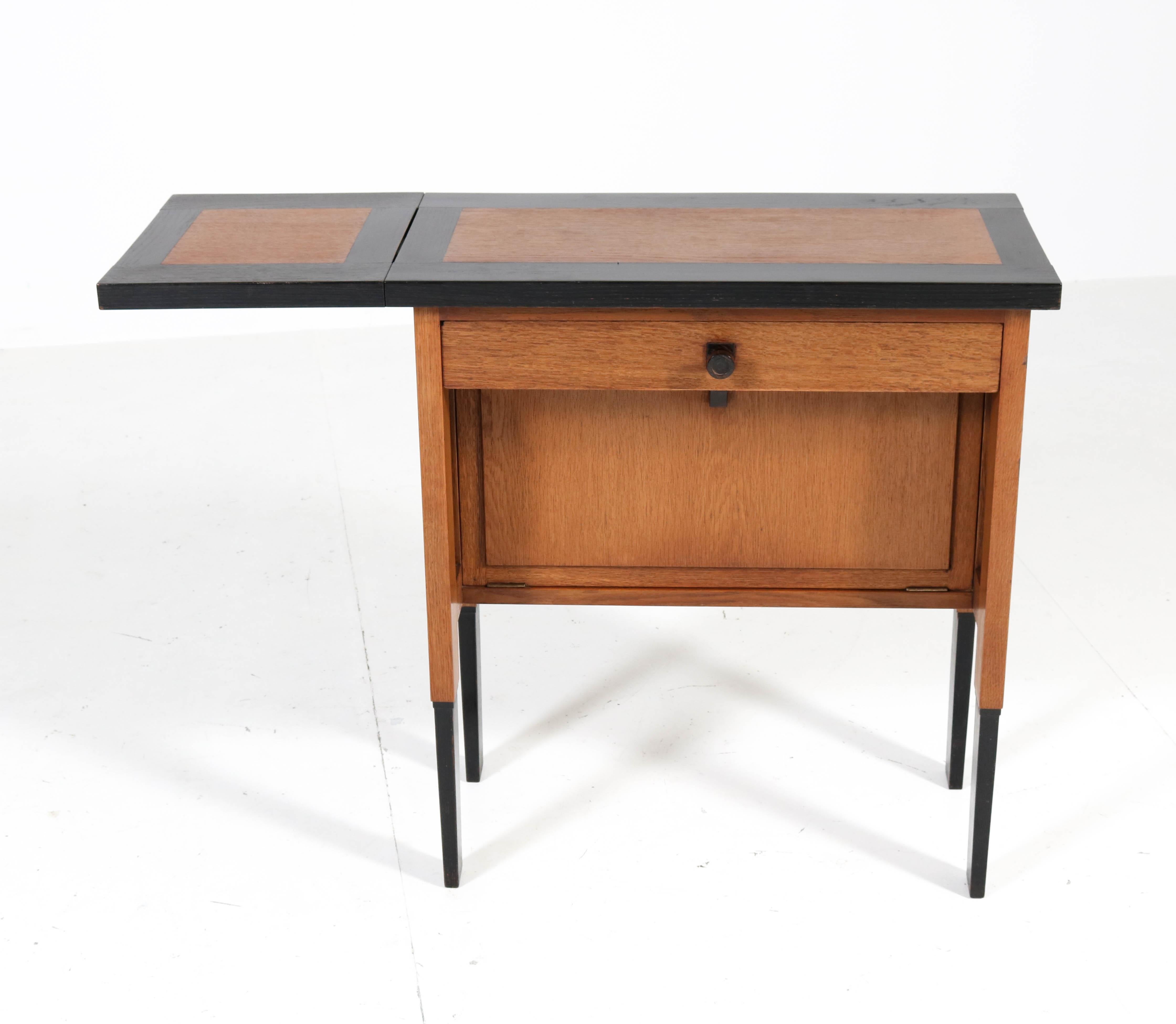 Magnificent and very rare Art Deco Haagse school cabinet or serving table.
Design by H. Fels for L.O.V. Oosterbeek.
Striking Dutch design from the twenties.
Oak with original black lacquered details.
Solid ebony Macassar knob and handle on the