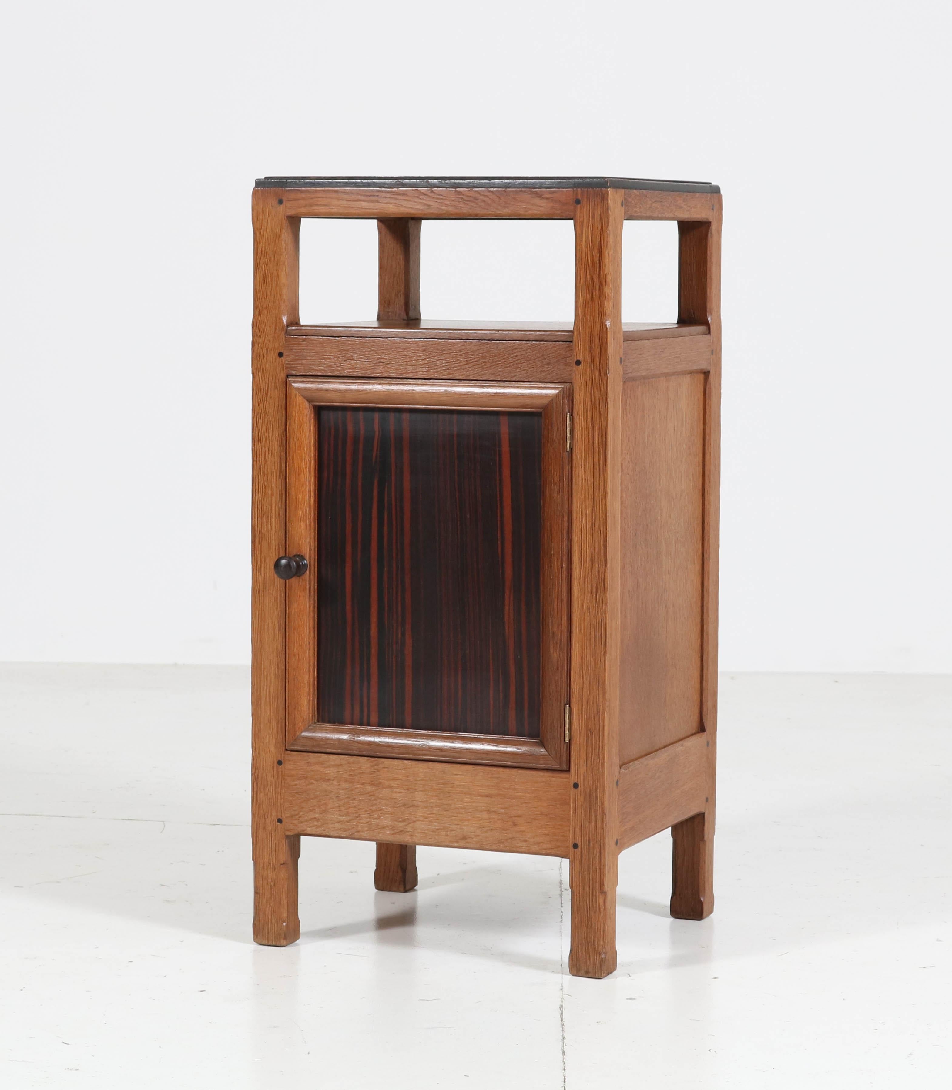 Wonderful and rare Art Deco Haagse School nightstand or bedside table.
Design by Paul Bromberg for H. Pander & Zonen Den Haag.
Striking Dutch design from the twenties.
Solid oak with ebony Macassar top and front.
Marked with original