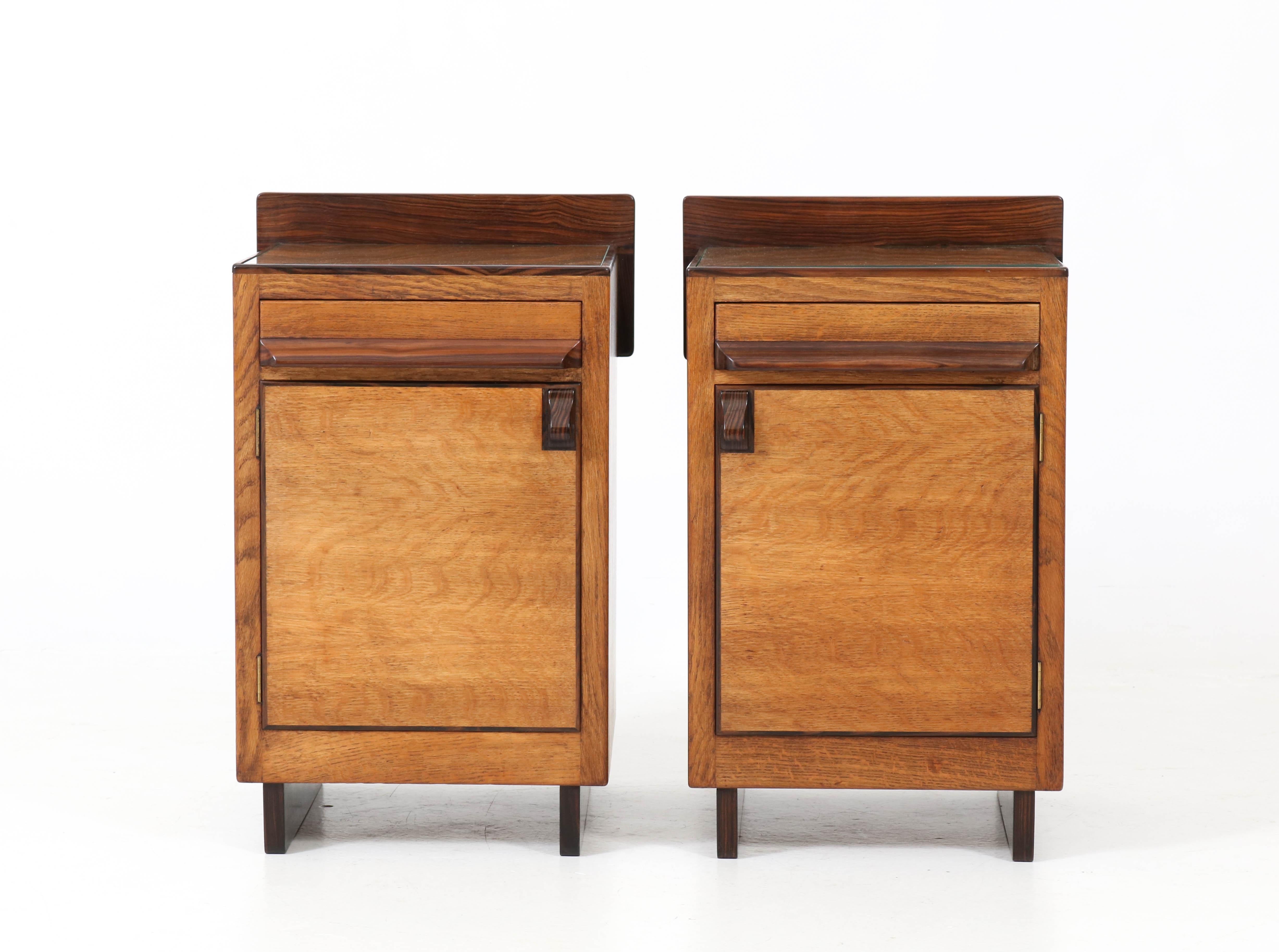 Stunning and rare Art Deco Haagse School nightstands or bedside tables.
Striking Dutch design in oak from the twenties.
Solid Macassar ebony handles on doors and drawers.
In good original condition with minor wear consistent with age and
