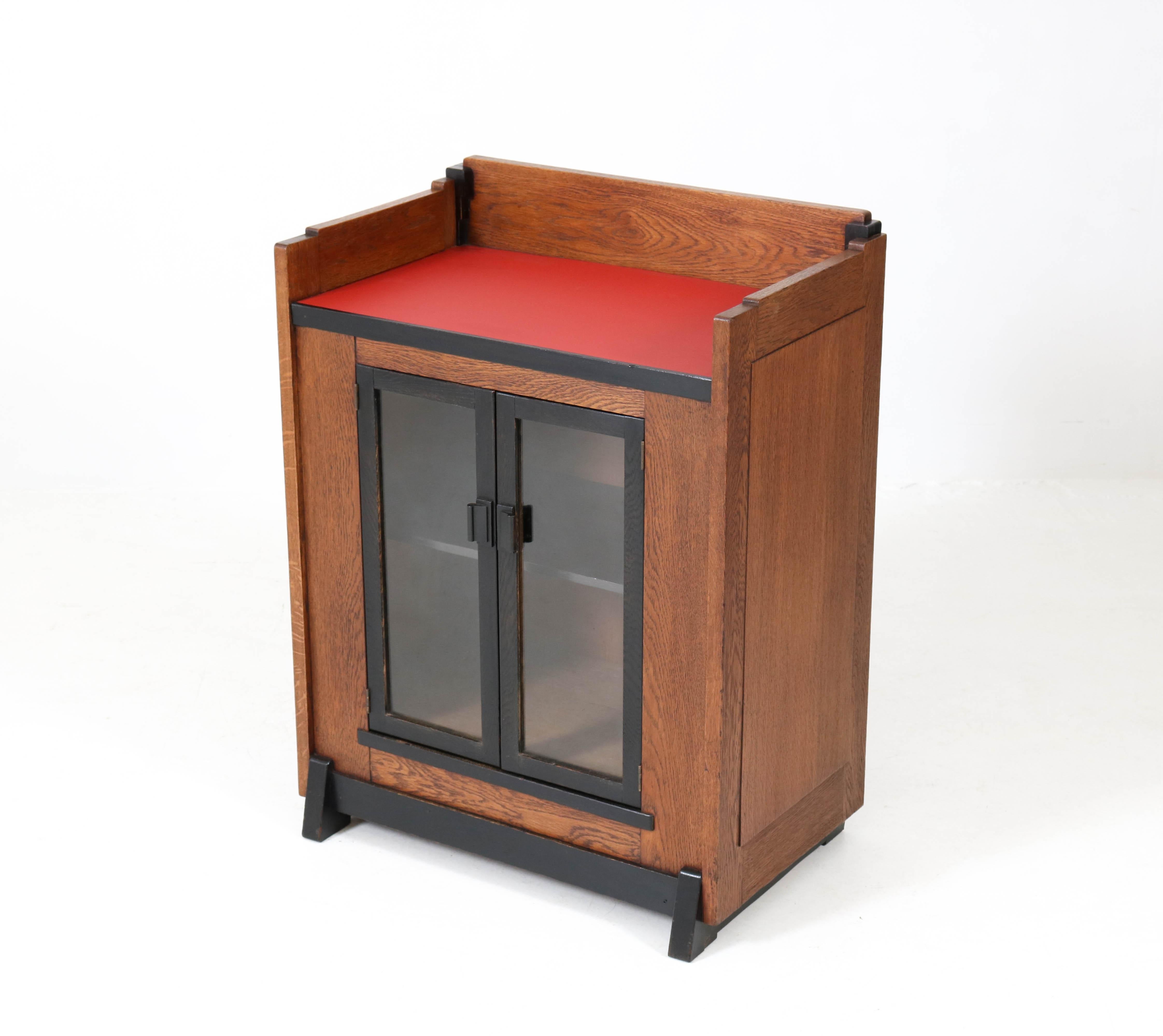 Offered by Amsterdam Modernism:
Rare and hard to find Art Deco Haagse School tea cabinet by Jan Brunott.
Oak with original ebonized lining and red linoleum top.
Striking Dutch design from the twenties.
In good original condition with minor wear