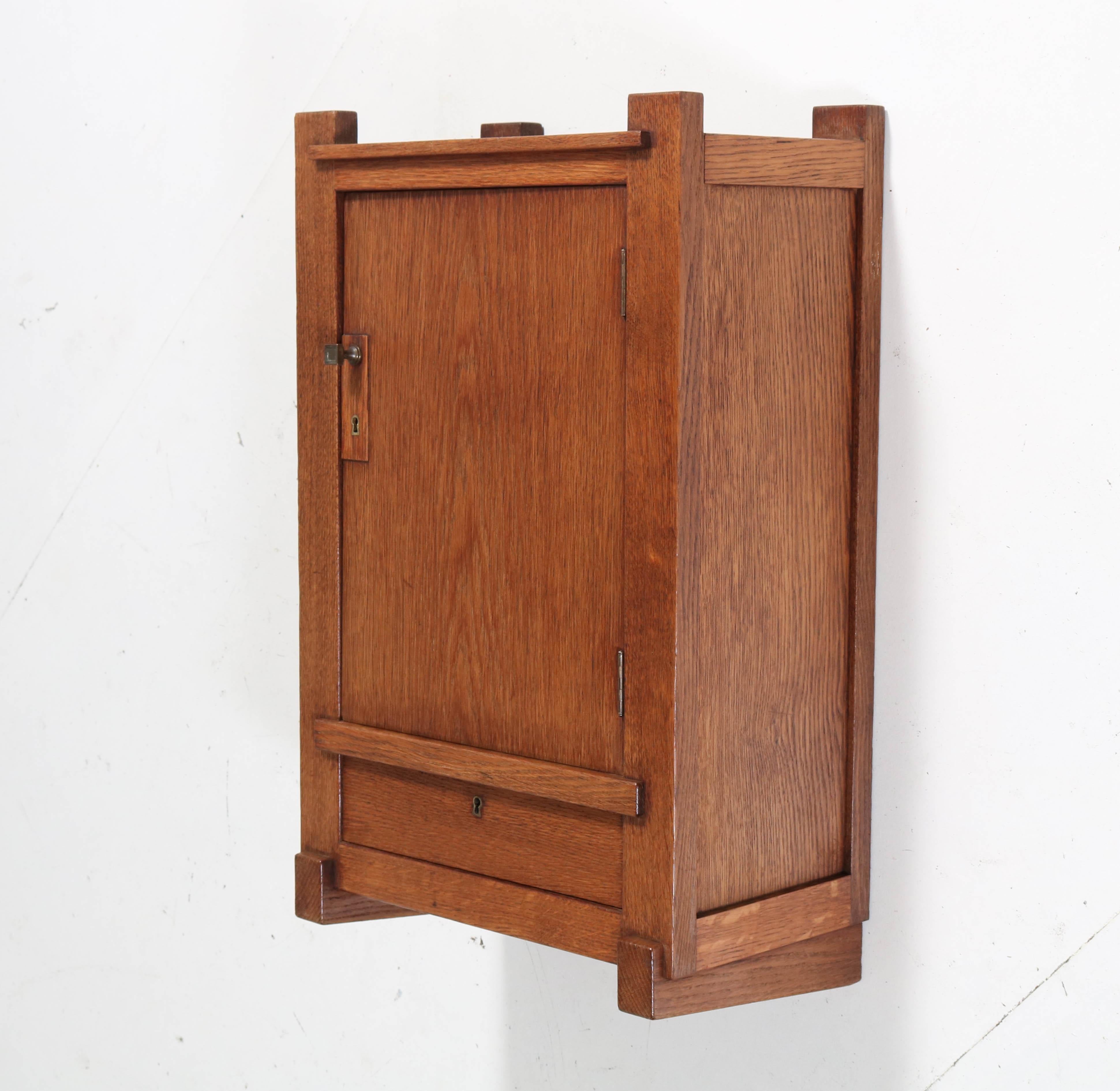 Stunning and rare Art Deco Haagse School wall cabinet.
Design by Hendrik Wouda for H. Pander & Zonen.
Striking Dutch design from the twenties.
Solid oak and marked with original metal tag.
In very good condition with minor wear consistent with age