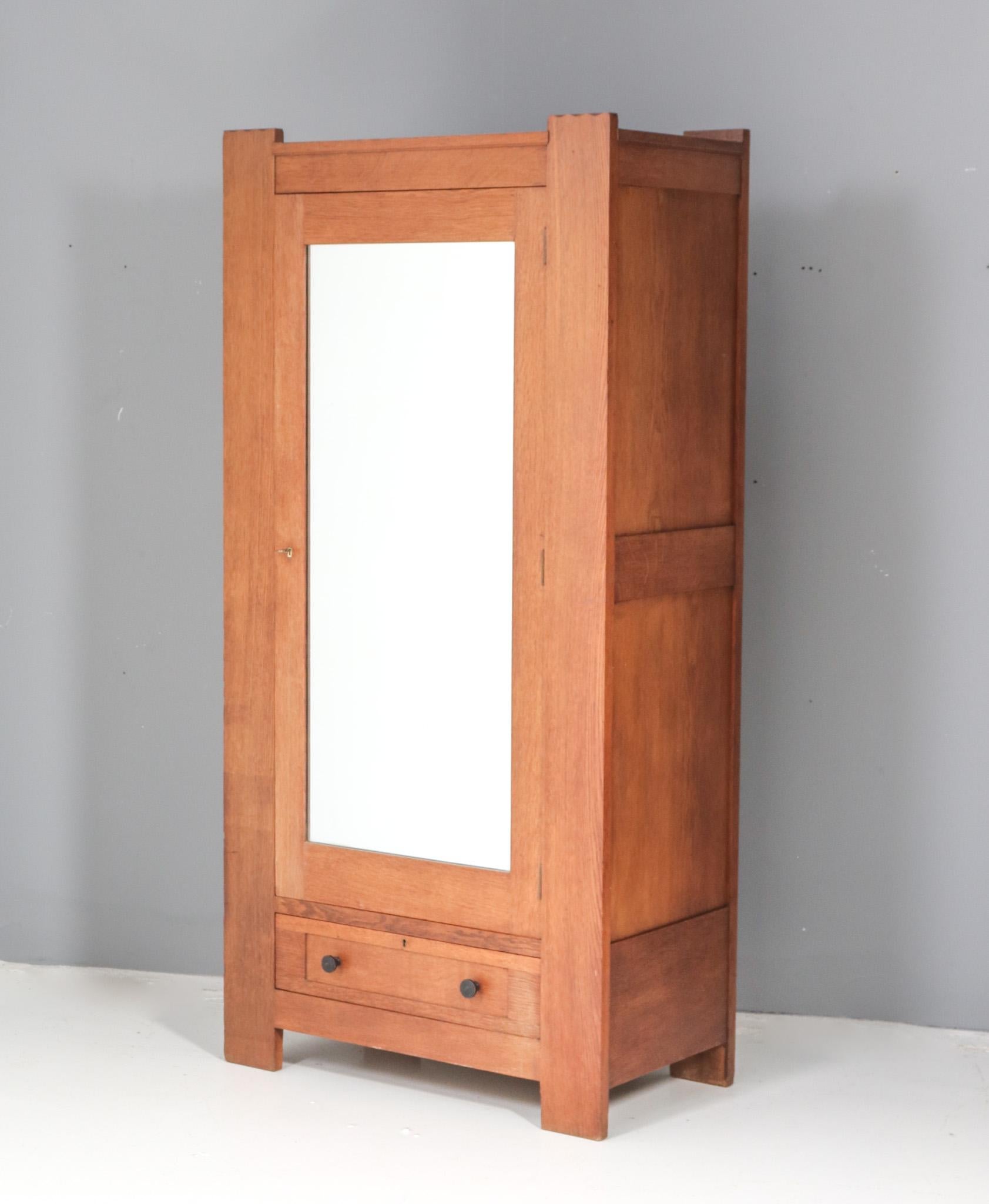 Magnificent and ultra rare Art Deco Modernist armoire or wardrobe.
Design by Hendrik Wouda for H. Pander & Zonen Den Haag.
Striking Dutch design from the 1920s.
Solid oak base with original black lacquered knobs on the drawer.
Behind the door with
