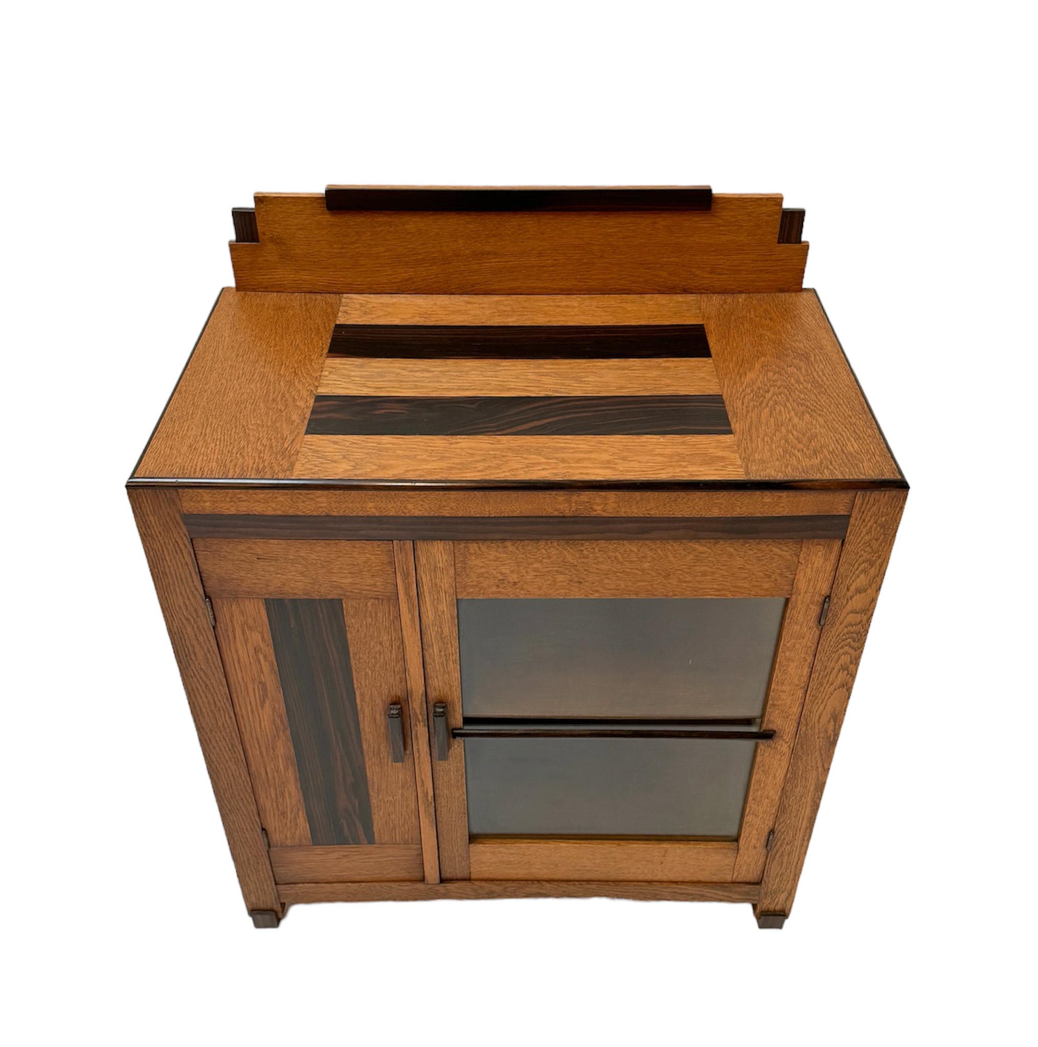 Stunning and rare Art Deco Modernist cabinet.
Striking Dutch design from the 1920s.
Solid oak and original oak veneered base with original macassar veneered lining.
Solid macassar handle on the door.
In very good original condition with minor wear