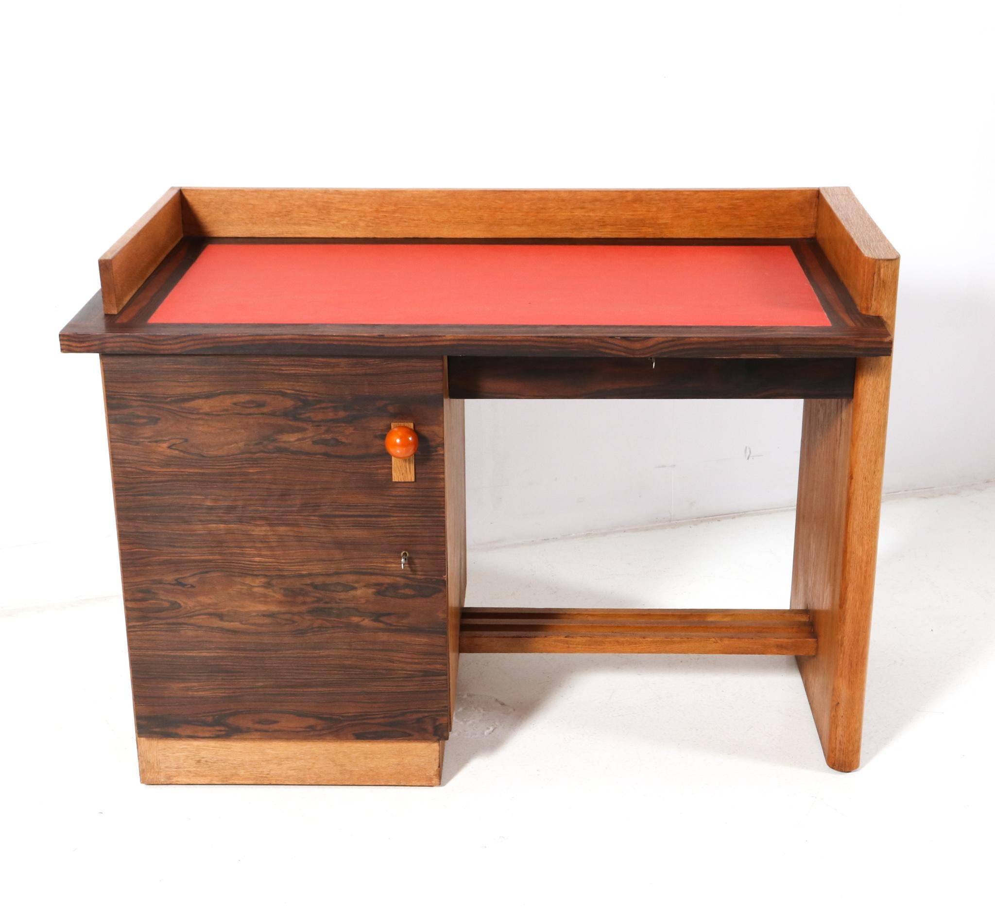 Magnificent and rare Art Deco Modernist small desk.
Design attributed to Jan Brunott.
Striking Dutch design from the 1920s.
Solid oak and original oak veneered base with new faux leather writing section.
Original macassar ebony veneered door and