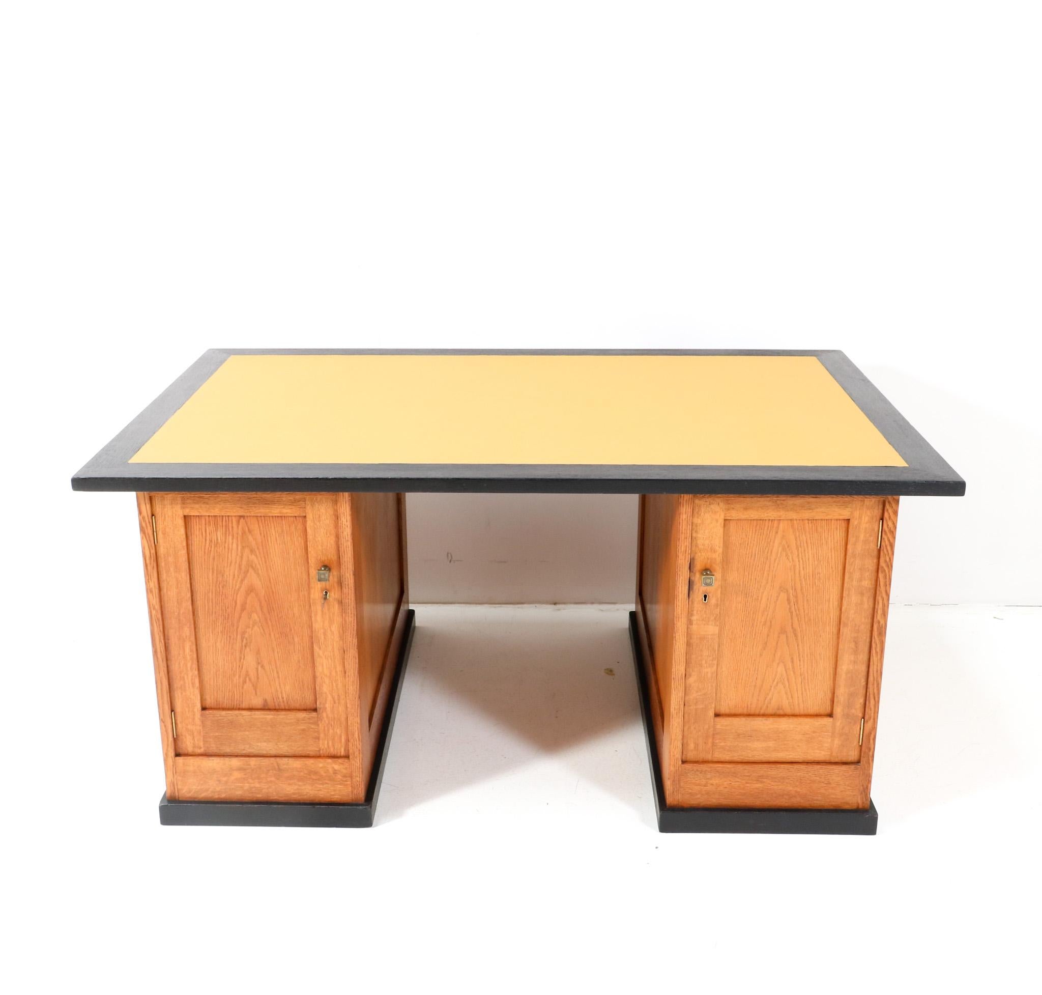 Magnificent and ultra rare Art Deco Modernist partner desk. Design by Hendrik Wouda for H. Pander & Zonen Den Haag. Striking Dutch design from the 1920s. Solid oak base with original patinated brass knobs on the four doors. Four original solid oak