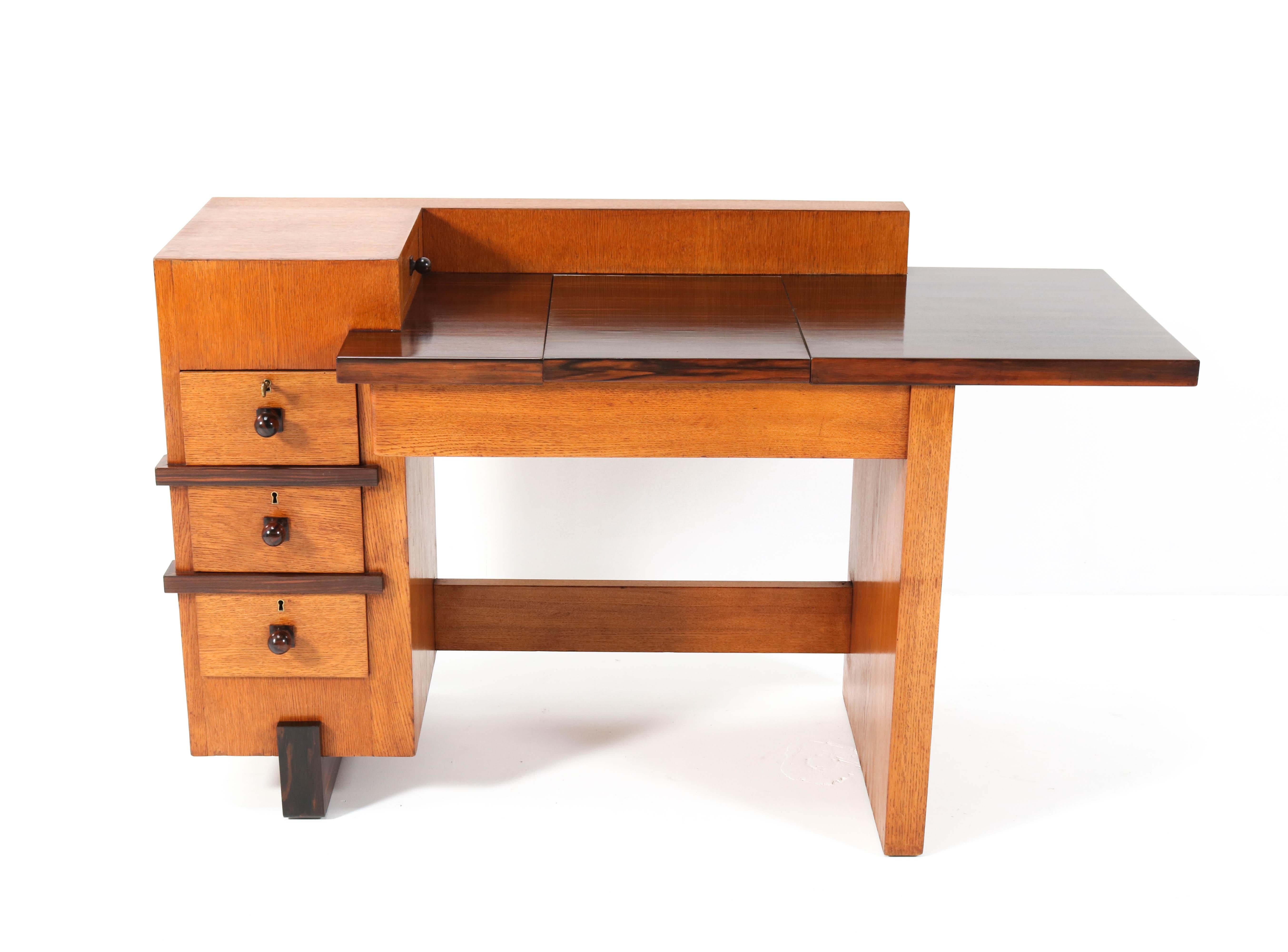 Magnificent and ultra rare Art Deco Modernist writing table. Design by Hendrik Wouda for H. Pander & Zonen Den Haag. Striking Dutch design from 1924.Solid oak and original oak veneered base with original solid macassar ebony knobs. The writing