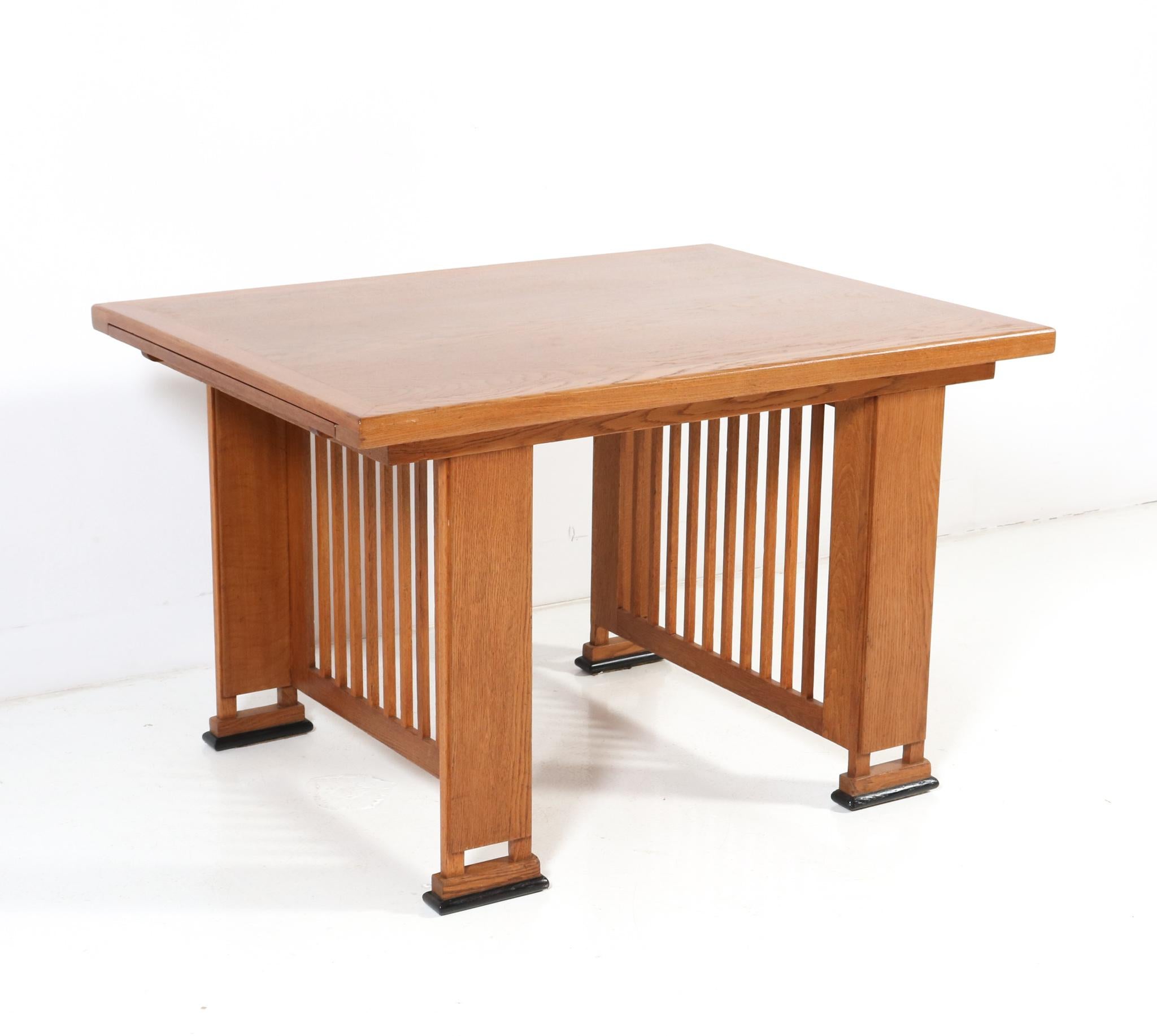 Magnificent and ultra rare Art Deco Modernist writing table or dining room table.
Design by architect Caspers.
Striking Dutch design from the 1920s.
Solid oak base with original oak veneered top.
Two extensions of 40 cm or 15.75 in.
In very