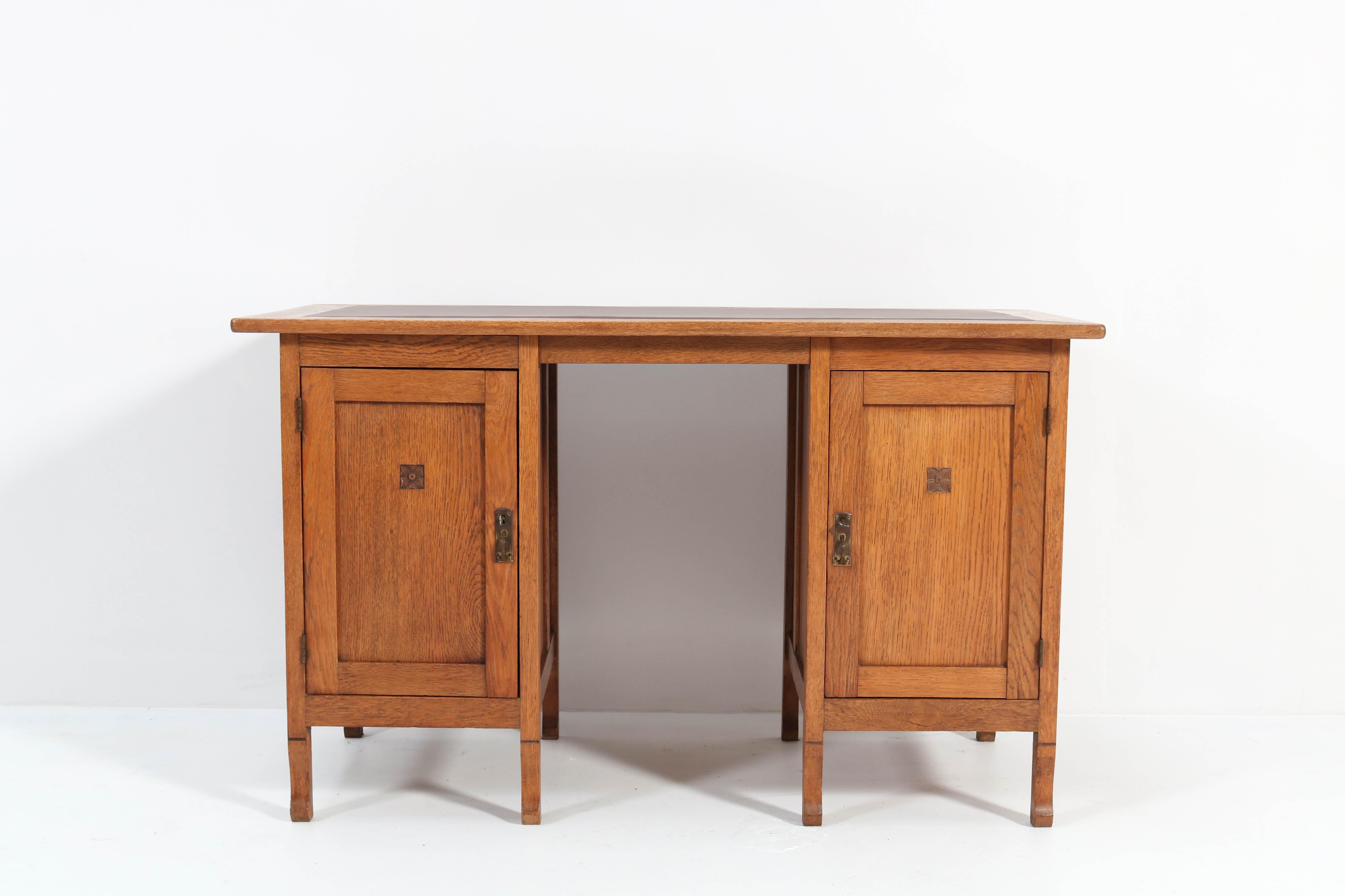 Stunning Art Nouveau Arts & Crafts pedestal desk.
Striking Dutch design from the 1900s.
Solid oak with original brass handles.
The top has a new faux leather writing section.
This wonderful piece of furniture can be dismantled into three pieces