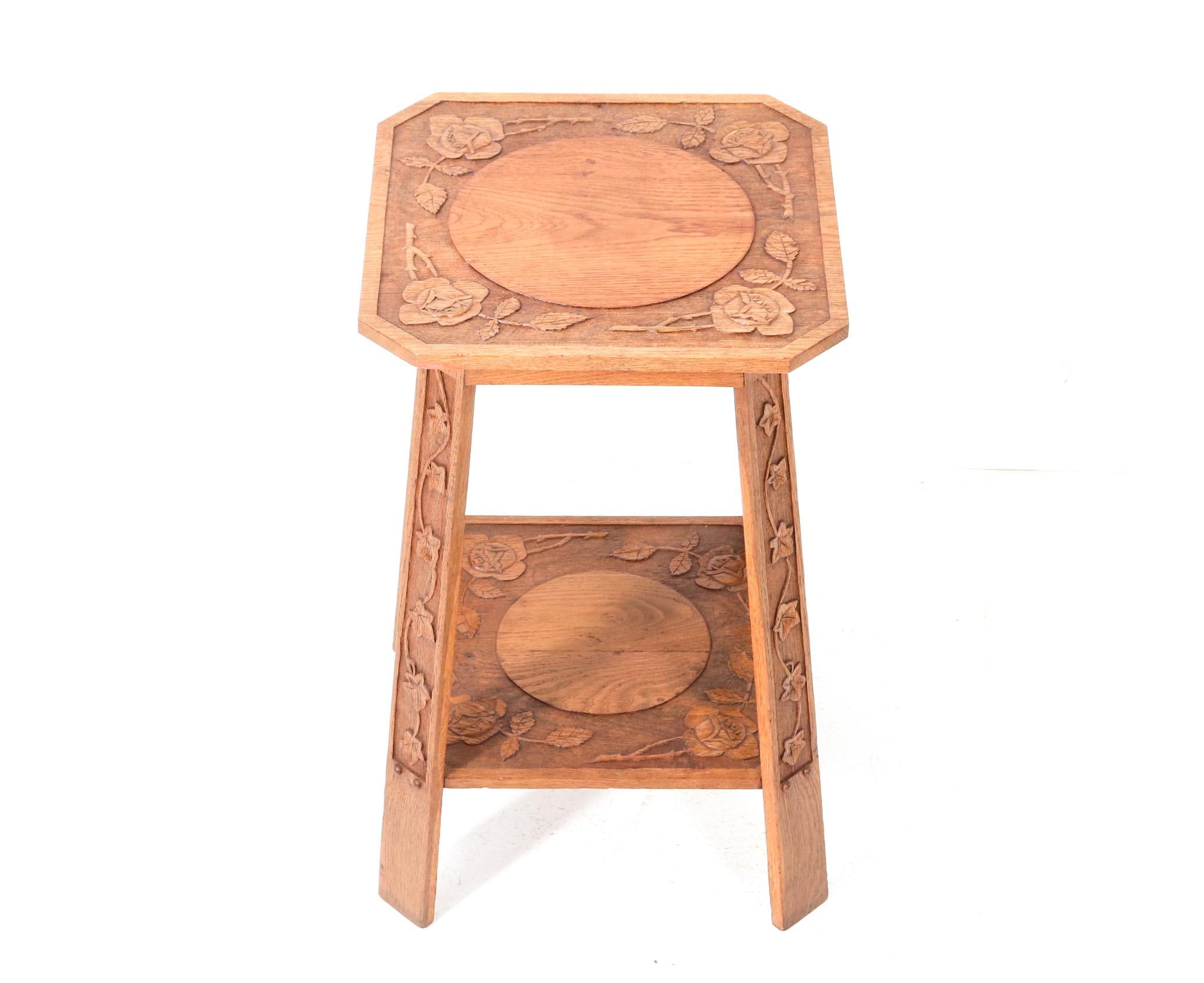 Stunning and rare Art Nouveau Arts & Crafts side table.
Striking Dutch design from the 1900s.
Solid oak frame with hand-carved flowers on top and legs.
This wonderful Art Nouveau Arts & Crafts side table is in very good condition with minor wear