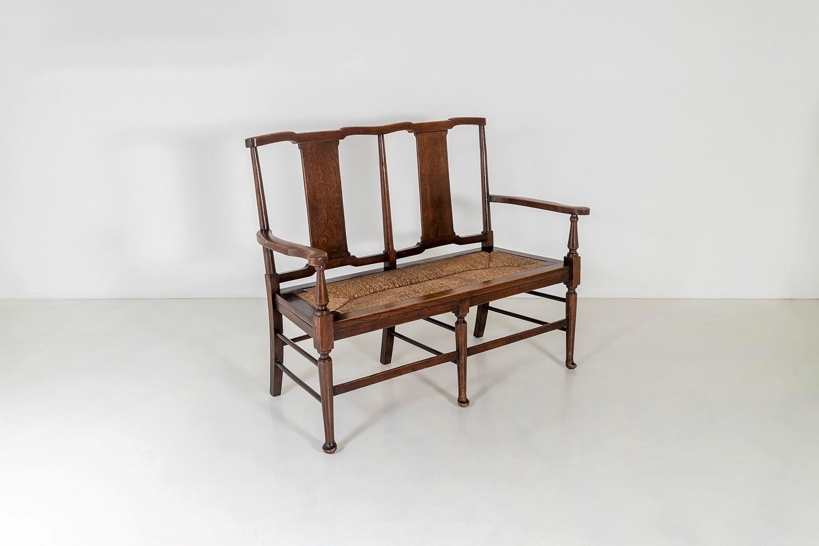 A very original, 19th century Oak two seater bench seat with original rush seat.
Dating to the Arts & Craft movement, this wonderful example is in the manner of Richard Norman Shaw for William Morris & Co.
The bench seat is a generous two seater,