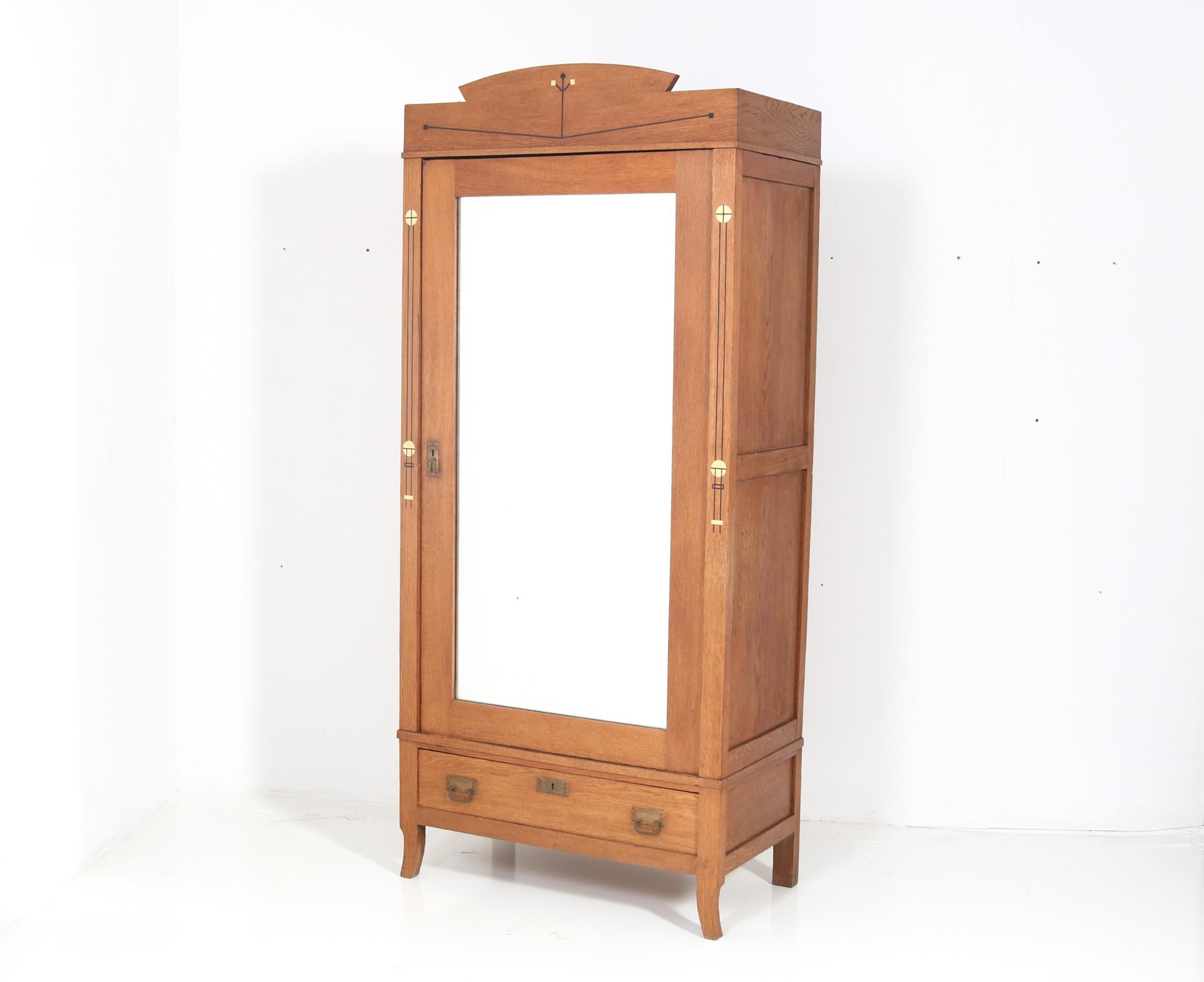 Magnificent and rare Arts & Crafts Art Nouveau armoire or wardrobe.
Striking Dutch design from the 1900s.
Solid oak with original brass handles on door and drawer.
Four original solid oak shelves adjustable in height.
The door has the original