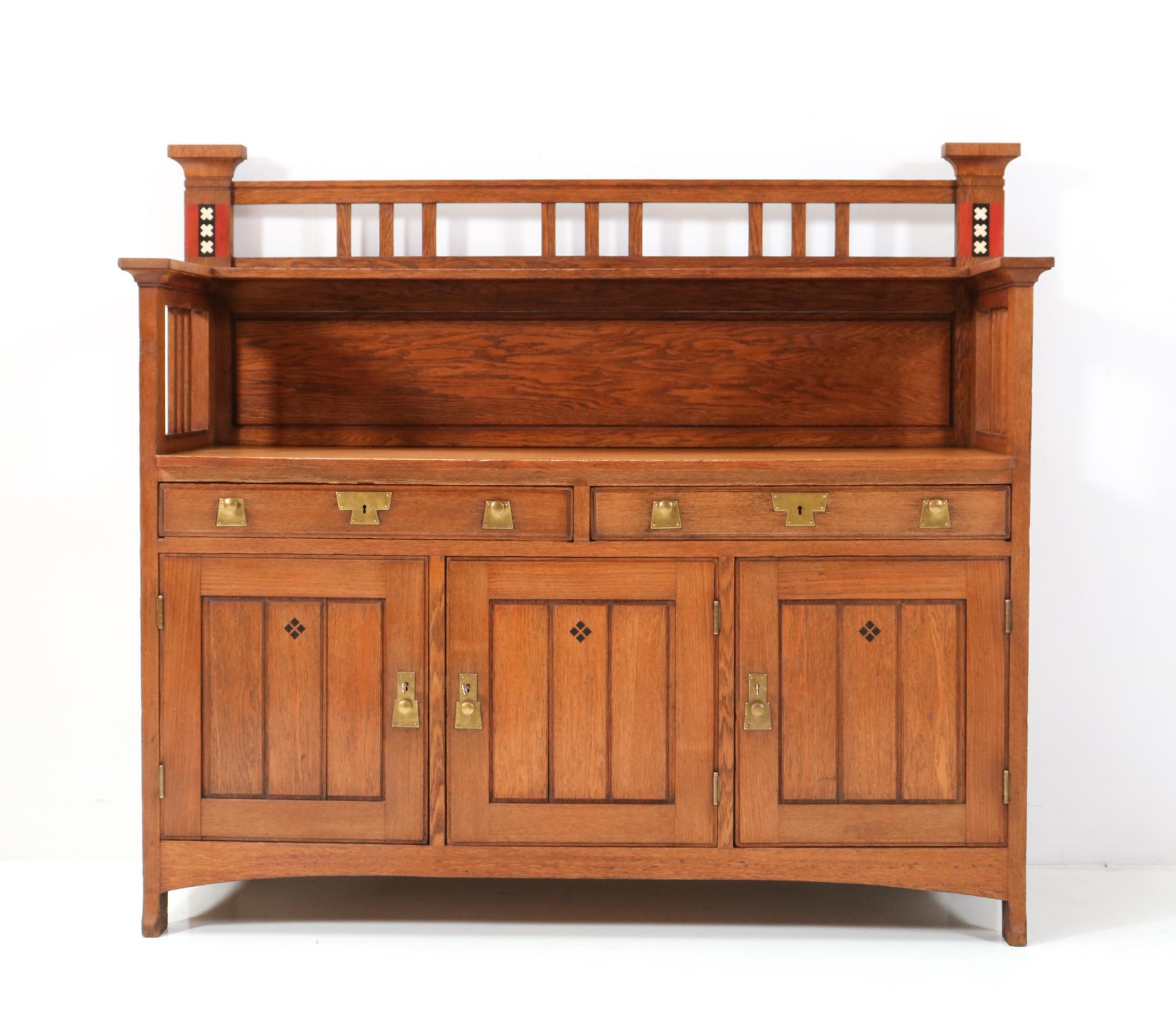Magnificent and ultra rare buffet or cupboard.
The design is attributed to the well known Royal furniture company H.F. Jansen & Zonen from Amsterdam.
Solid oak with original brass knobs on doors and drawers.
Decorated with the coat of arms of the