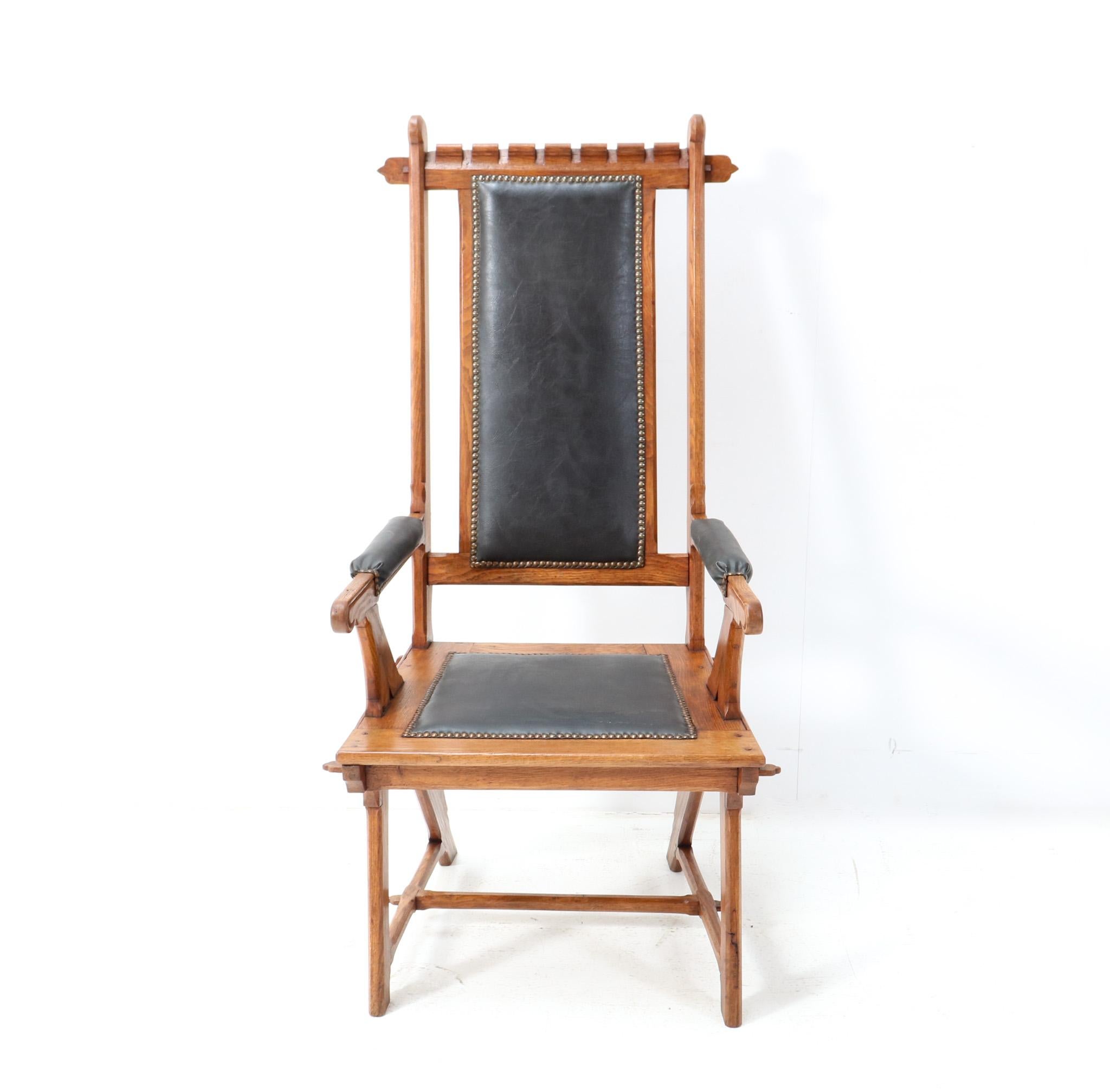 Magnificent and rare Arts & Crafts Art Nouveau high back armchair.
Design attributed to H.P. Berlage.
Solid oak frame with stylish carved elements.
Re-upholstered with brown faux leather.
The legs have the so-called A-construction which H.P.
