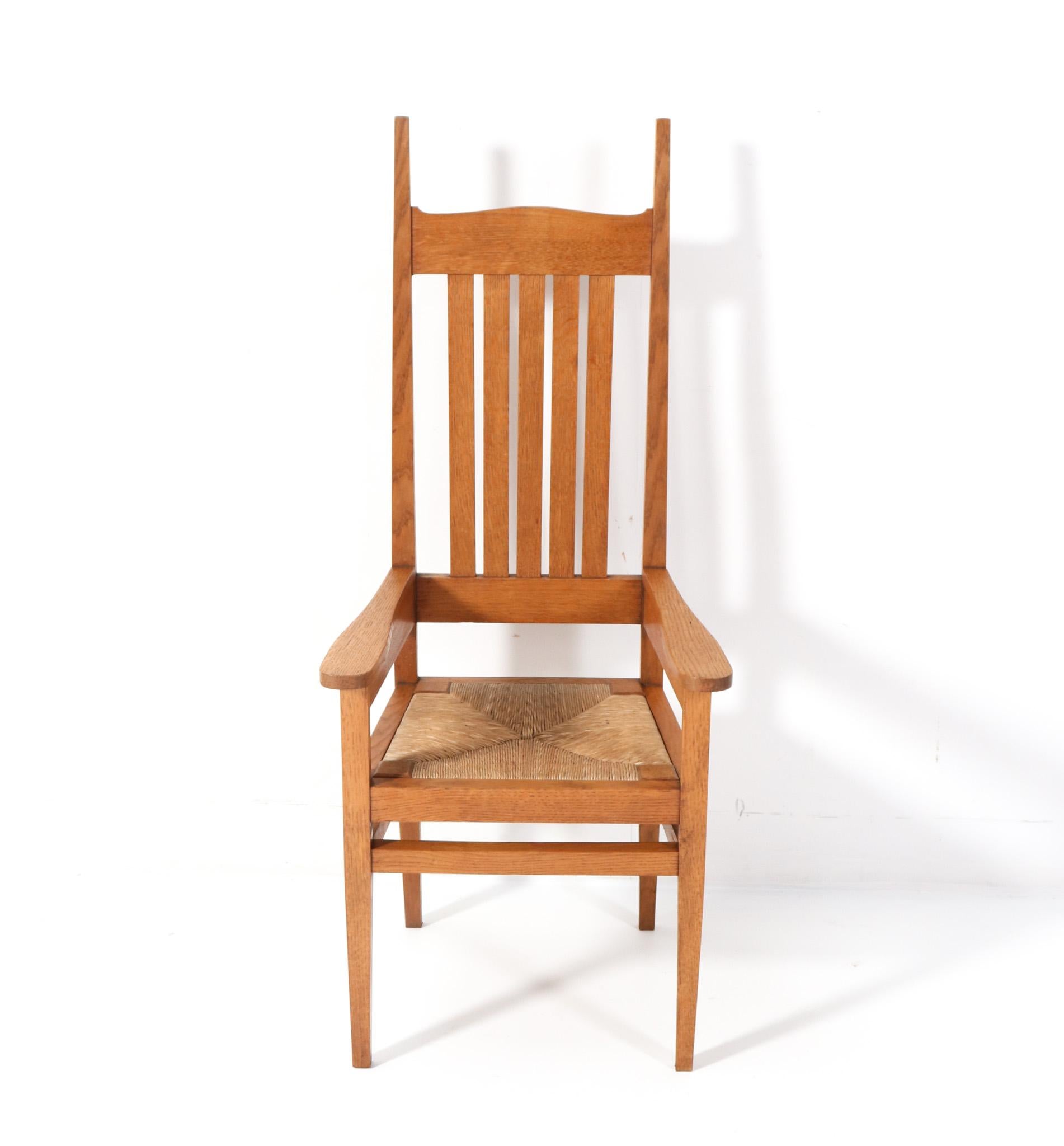 Magnificent and rare Arts & Crafts ladies high-back armchair.
Design by Charles Francis Annesley Voysey.
Striking English design from the 1900s.
Solid oak frame with original rush seat.
This wonderful Arts & Crafts ladies high-back armchair by