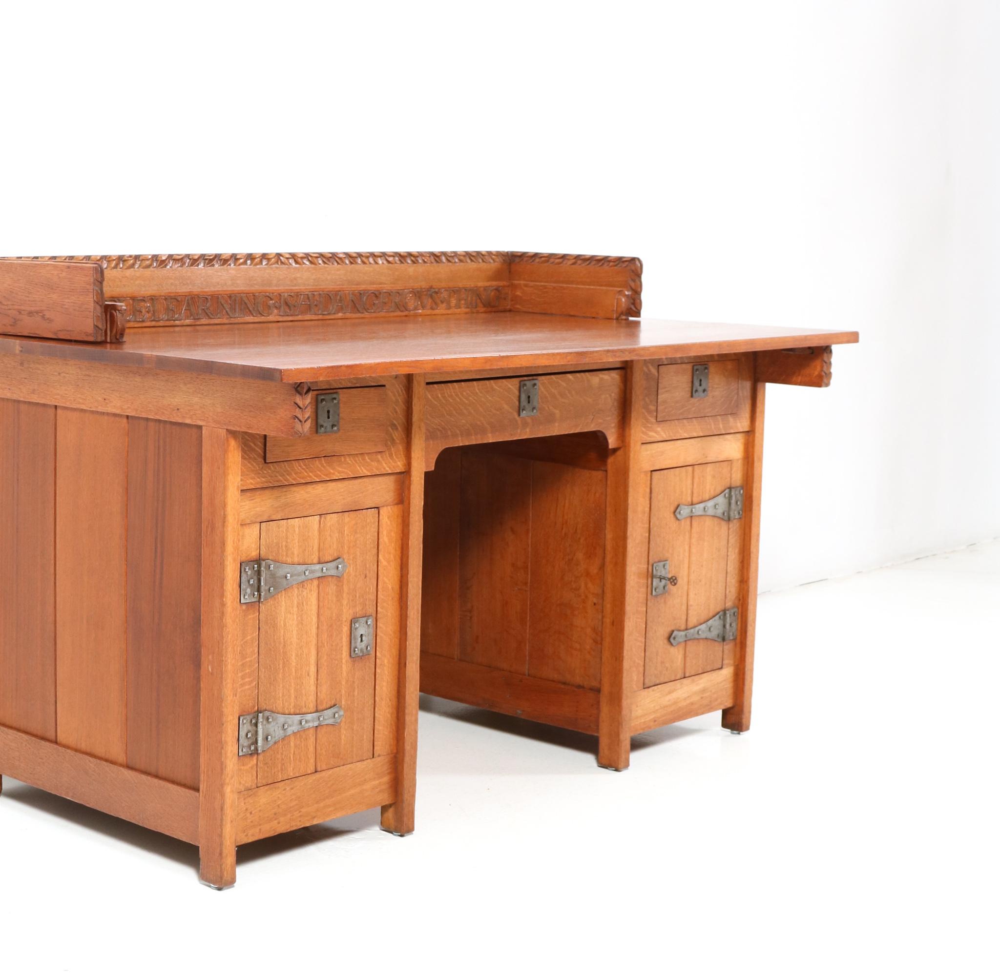 Magnificent and ultra rare Arts & Crafts pedestal desk.
Design by Alexander J. Kropholler.
Striking Dutch design from the 1890s.
Executed in solid oak and original wrought iron, this stunning and one of a kind museum piece has a hand-carved